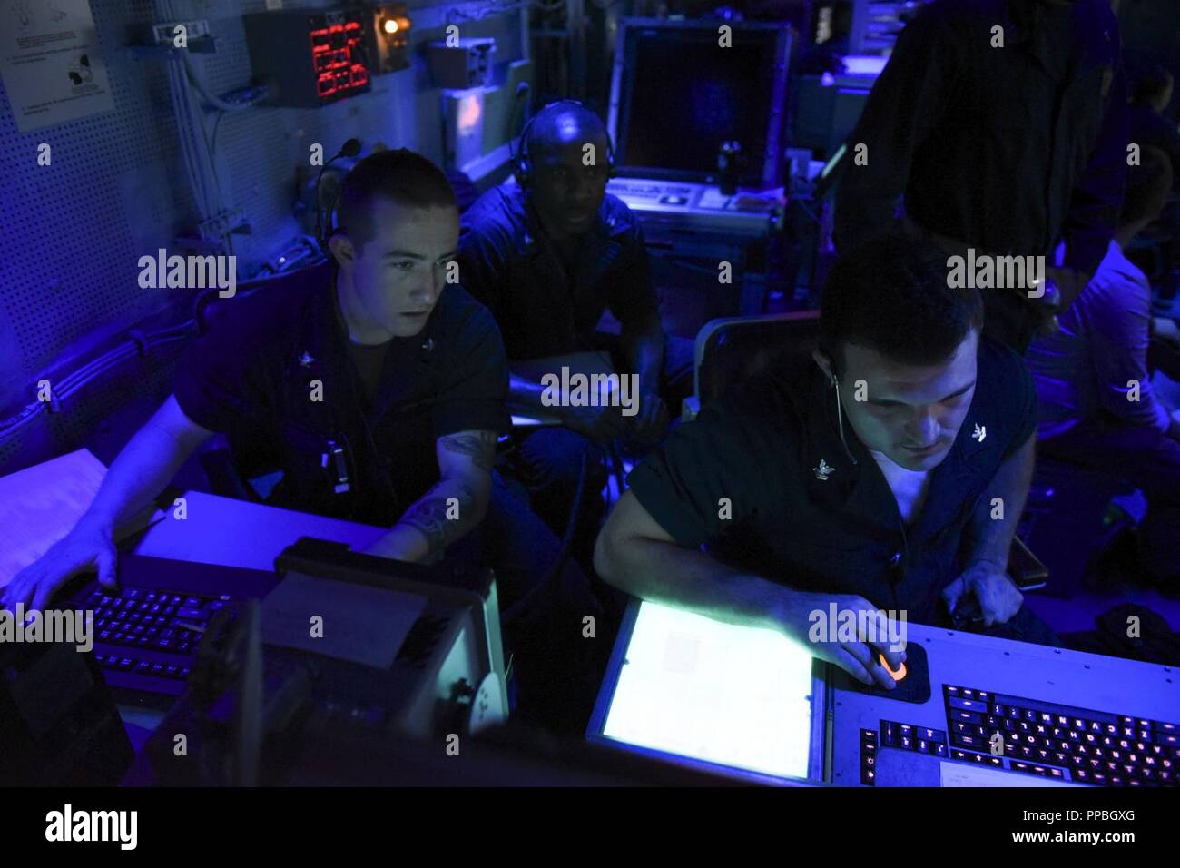 ATLANTIC OCEAN (Aug. 22, 2018) Sailors assigned to the Nimitz-class aircraft carrier USS Abraham Lincoln (CVN 72) stand watch in the ship’s carrier air traffic control center. Abraham Lincoln is currently underway conducting carrier qualifications. Stock Photo