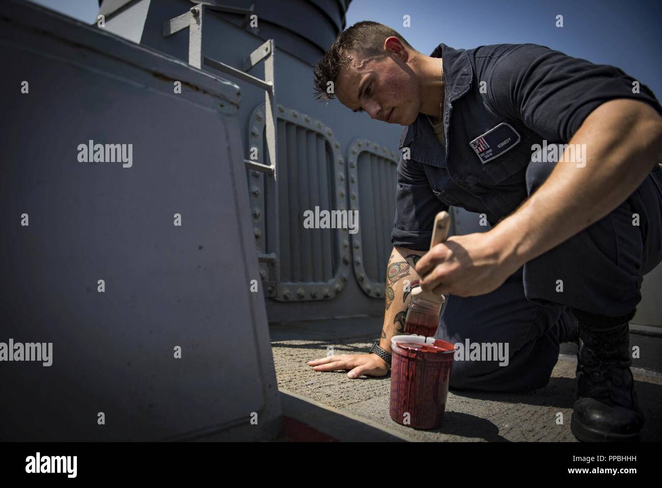 SEA (Aug. 28, 2018) Gunner’s Mate Seaman Jordan Kennedy paints aboard the Arleigh Burke-class guided-missile destroyer USS Carney (DDG 64) Aug. 28, 2018. Carney, forward-deployed to Rota, Spain, is on its fifth patrol in the U.S. 6th Fleet area of operations in support of regional allies and partners as well as U.S. national security interests in Europe and Africa. Stock Photo