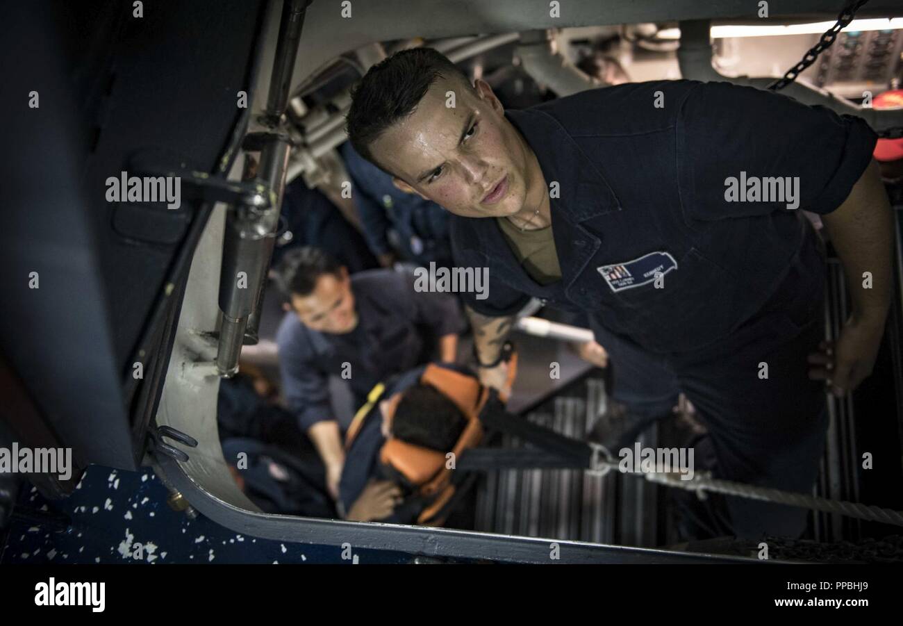 SEA (Aug. 28, 2018) Gunner’s Mate Seaman Jordan Kennedy participates in stretcher bearer training aboard the Arleigh Burke-class guided-missile destroyer USS Carney (DDG 64) Aug. 28, 2018. Carney, forward-deployed to Rota, Spain, is on its fifth patrol in the U.S. 6th Fleet area of operations in support of regional allies and partners as well as U.S. national security interests in Europe and Africa. Stock Photo