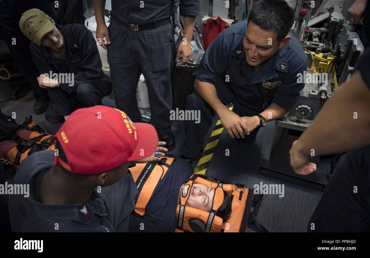 SEA (Aug. 28, 2018) Chief Hospital Corpsman Andres Naranjo, right, provides stretcher bearer training aboard the Arleigh Burke-class guided-missile destroyer USS Carney (DDG 64) Aug. 28, 2018. Carney, forward-deployed to Rota, Spain, is on its fifth patrol in the U.S. 6th Fleet area of operations in support of regional allies and partners as well as U.S. national security interests in Europe and Africa. Stock Photo