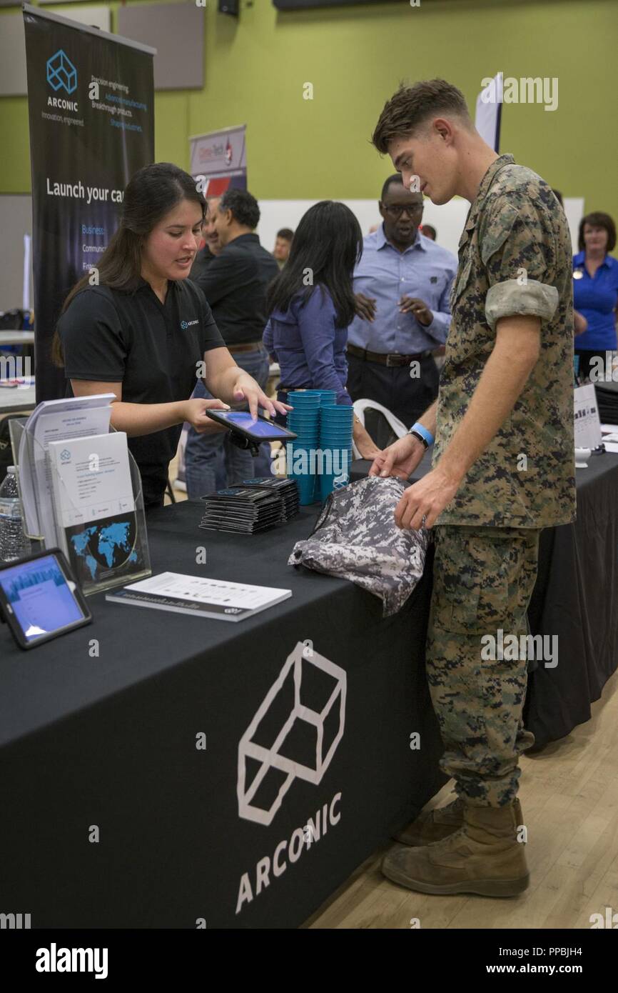 U S Marine Corps Cpl Nicholas Heln Right Infantryman 2nd Battalion 1st Marine Regiment 1st Marine Division Listens To Yovanna Iniguez Human Research Generalist Arconic Give Him Information About Her Job During A