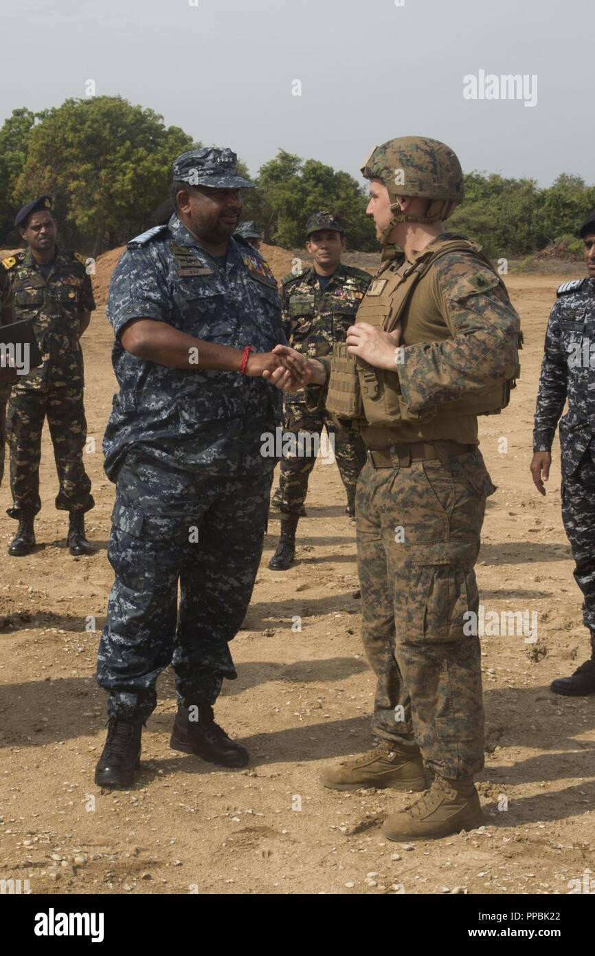 Sri Lanka –Chief of Defence Staff, Adm. Ravindra Wijegunaratne, presents a  challenge coin to U.S. Marine Corps Sgt. Christopher Kolakowski, a squad  leader with India Company, Battalion Landing Team 3/1, 13th Marine