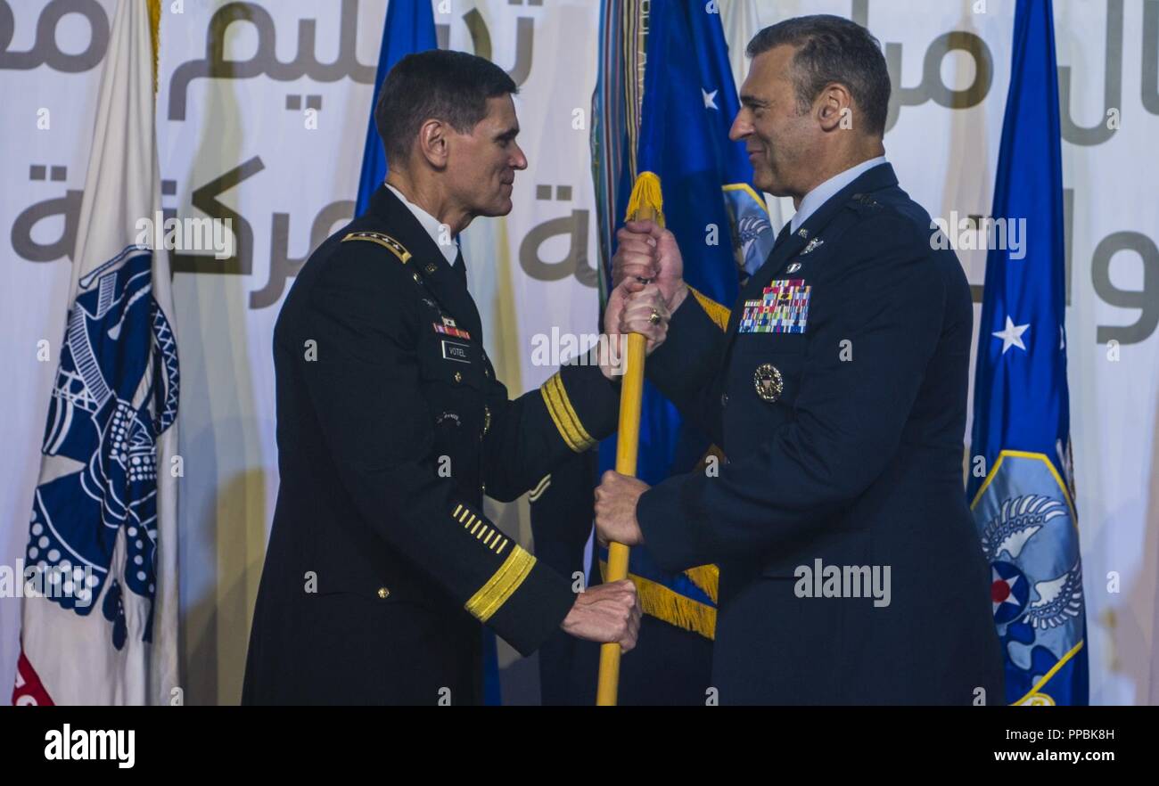 U.S. Army Gen. Joseph L. Votel, Commander of U.S. Central Command (CENTCOM), passes the guidon to U.S. Air Force Lt. Gen. Joseph T. Guastella Jr., Commander of U.S. Air Forces Central Command (AFCENT), during a change of command ceremony at Al Udeid Air Base, Qatar, Aug. 30, 2018. As the Combined Force Air Component Commander for CENTCOM, Guastella is responsible for developing contingency plans and conducting air operations in a 20-nation area of responsibility covering Central and Southwest Asia. AFCENT, in concert with coalition, joint, and interagency partners, delivers decisive air, space Stock Photo