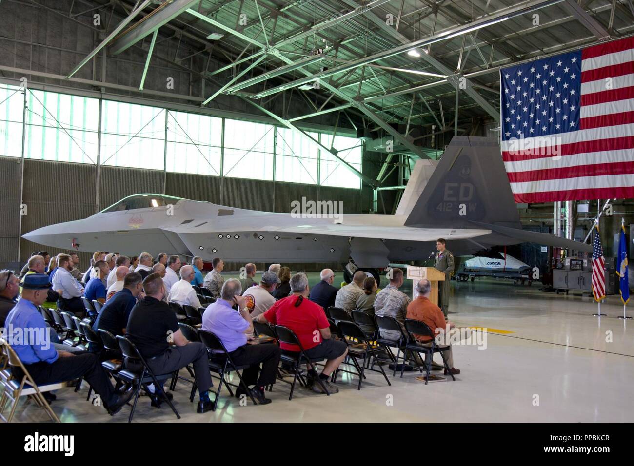 Lt. Col. Lee Bryant, 411th Flight Test Squadron commander and F-22 Combined Test Force director, addresses base leadership along with Lockheed Martin and Boeing representatives and guests, to welcome back to life Raptor # 91-4006, which has been on the ground for almost six years. Stock Photo