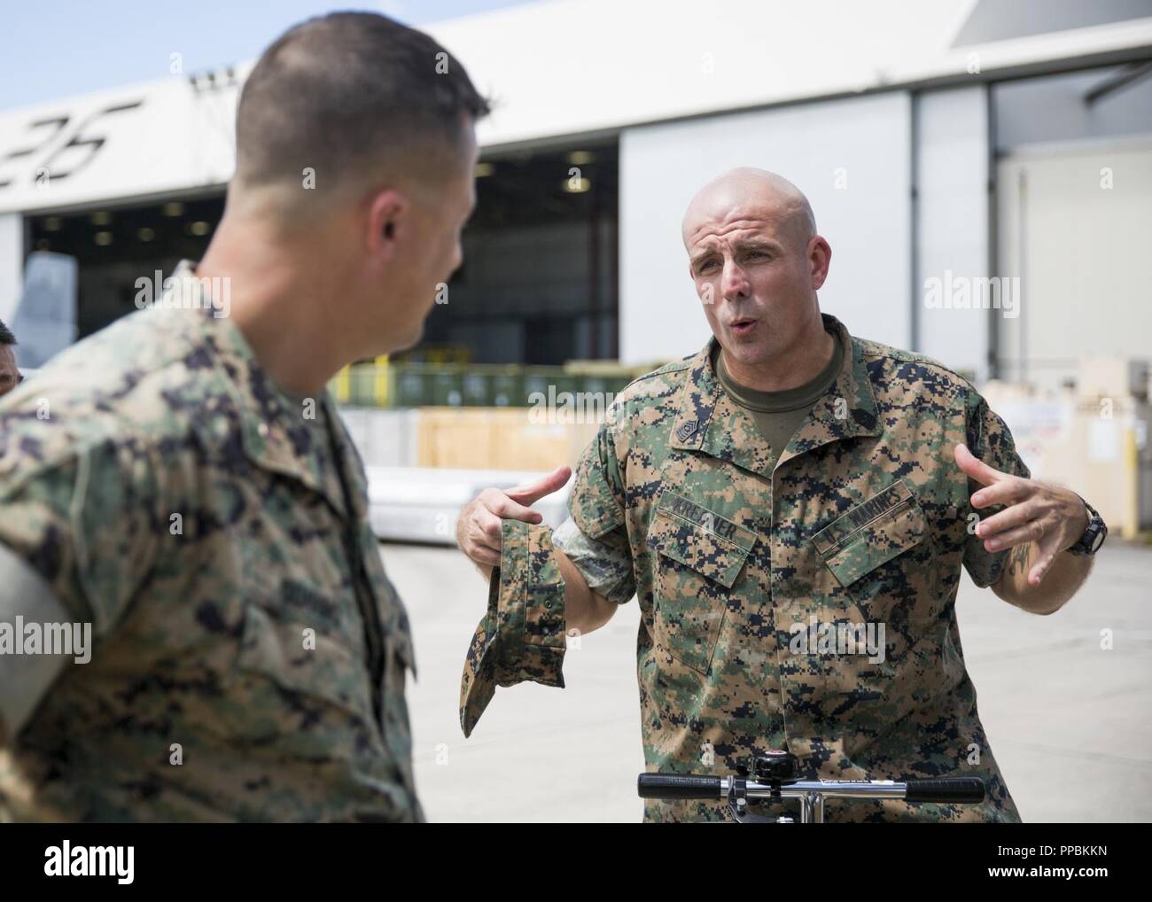 U.S. Marine Corps Sgt.Maj. Howard L. Kreamer speaks to a Marine with Marine Medium Tiltrotor Squadron 365 during a visitation on Marine Corps Air Station New River, August 28, 2018. Sgt.Maj. Kreamer visited squadrons to assist the Marine Forces Command, commanding general, orient himself on the current status of 2d Maw. Kreamer is the Sgt.Maj. of 2nd Marine Aircraft Wing. Stock Photo
