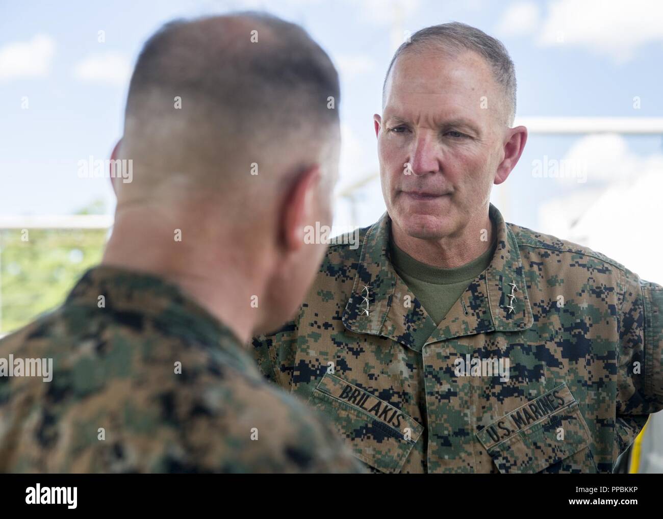 U.S. Marine Corps Lt.Gen. Mark A. Brilakis speaks to a Marine with Marine Medium Tiltrotor Squadron 365 during a visitation on Marine Corps Air Station New River, August 28, 2018. Lt.Gen. Brilakis visited the 2nd Marine Aircraft Wing (2d MAW) in order to orient himself on the current status of 2d Maw. Brilakis is the commanding general of Marine Forces Command. Stock Photo