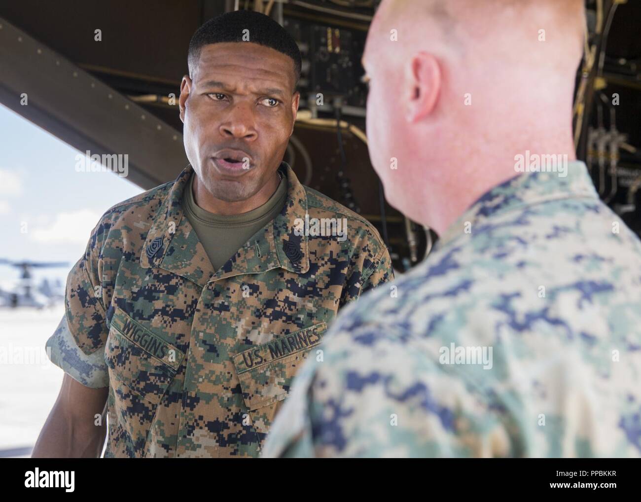 U.S. Marine Corps Sgt.Maj. Clifford W. Wiggins speaks to a Marine with Marine Medium Tiltrotor Squadron 365 during a visitation on Marine Corps Air Station New River, August 28, 2018. Sgt.Maj. Wiggins visited squadrons to assist the Marine Forces Command, commanding general, orient himself on the current status of 2d Maw. Wiggins is the Sgt.Maj. of Marine Forces Command. Stock Photo