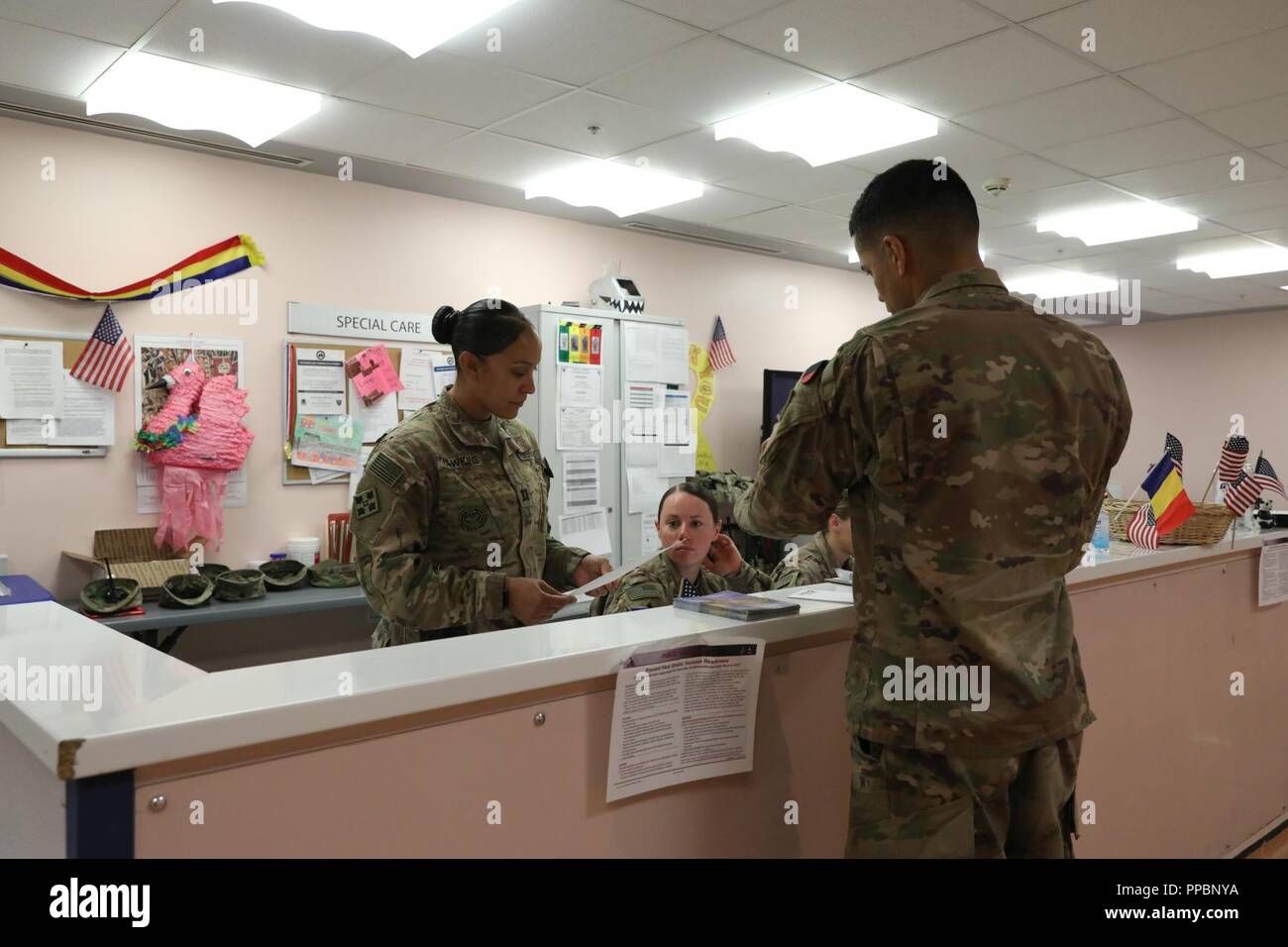 KANDAHAR, Afghanistan — Capt. Jennifer Hawkins, medical provider for 1st Battalion, 12th Infantry Regiment, 2nd Infantry Brigade Combat Team, 4th Infantry Division, reviews paperwork with her Soldiers, Aug. 13, 2018, at the Kandahar Airfield NATO Role III Multinational Medical Unit in Kandahar Airfield, Afghanistan. ( Stock Photo