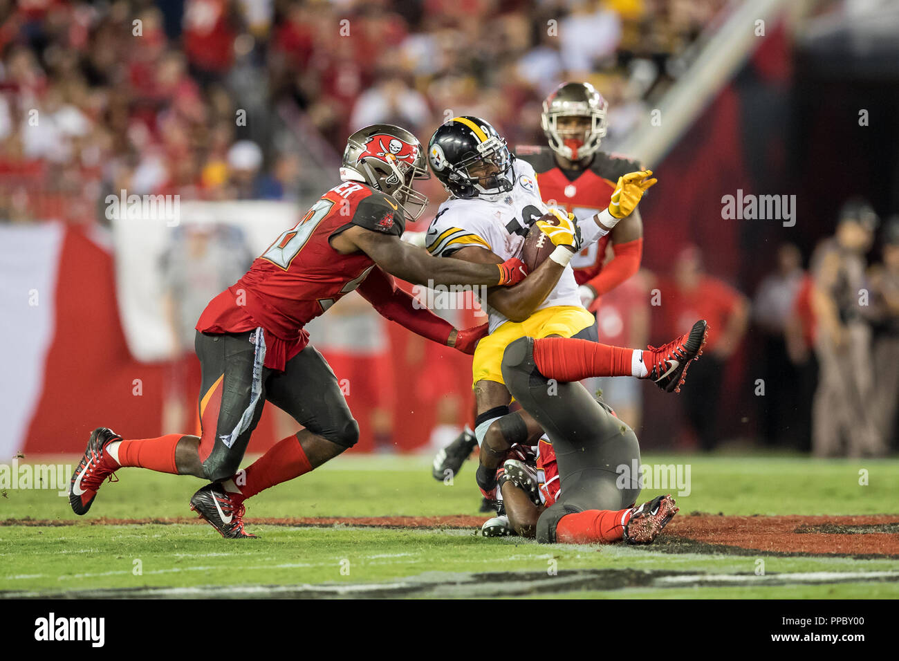 Tampa, Florida, USA. 24th Sep, 2018. Pittsburgh Steelers running back James Conner (30) is brought down by Tampa Bay Buccaneers linebacker Lavonte David (54) during the game at Raymond James Stadium on Monday September 24, 2018 in Tampa, Florida. Credit: Travis Pendergrass/ZUMA Wire/Alamy Live News Stock Photo