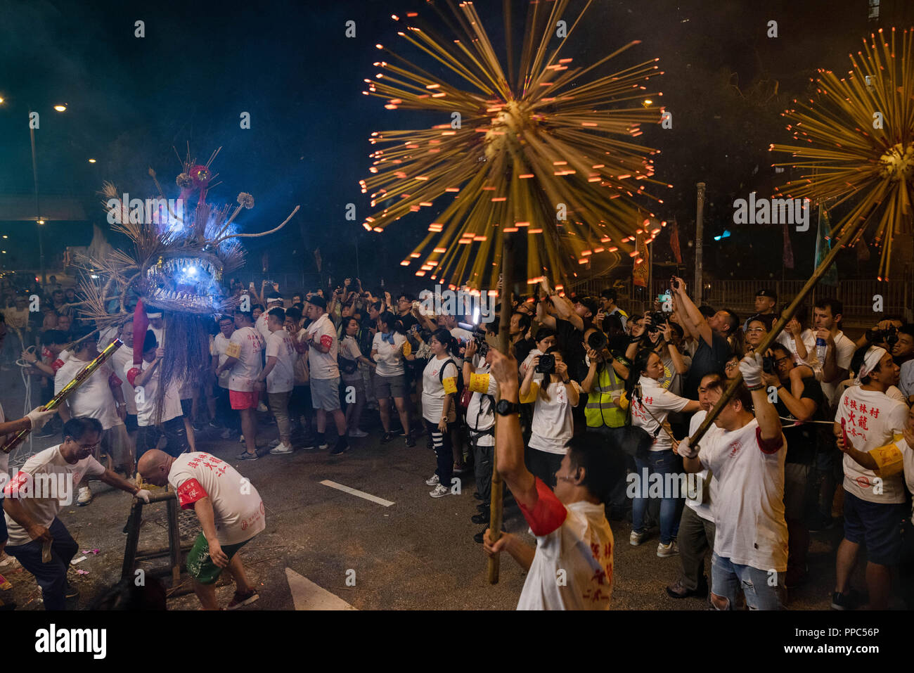 Hong Kong, China. 24th Sep, 2018. Performers carry a stuffed dragon with  hundreds of incense sticks during the celebration of the mid-autumn  festival in Pok Fu Lam village in Hong Kong. Credit: