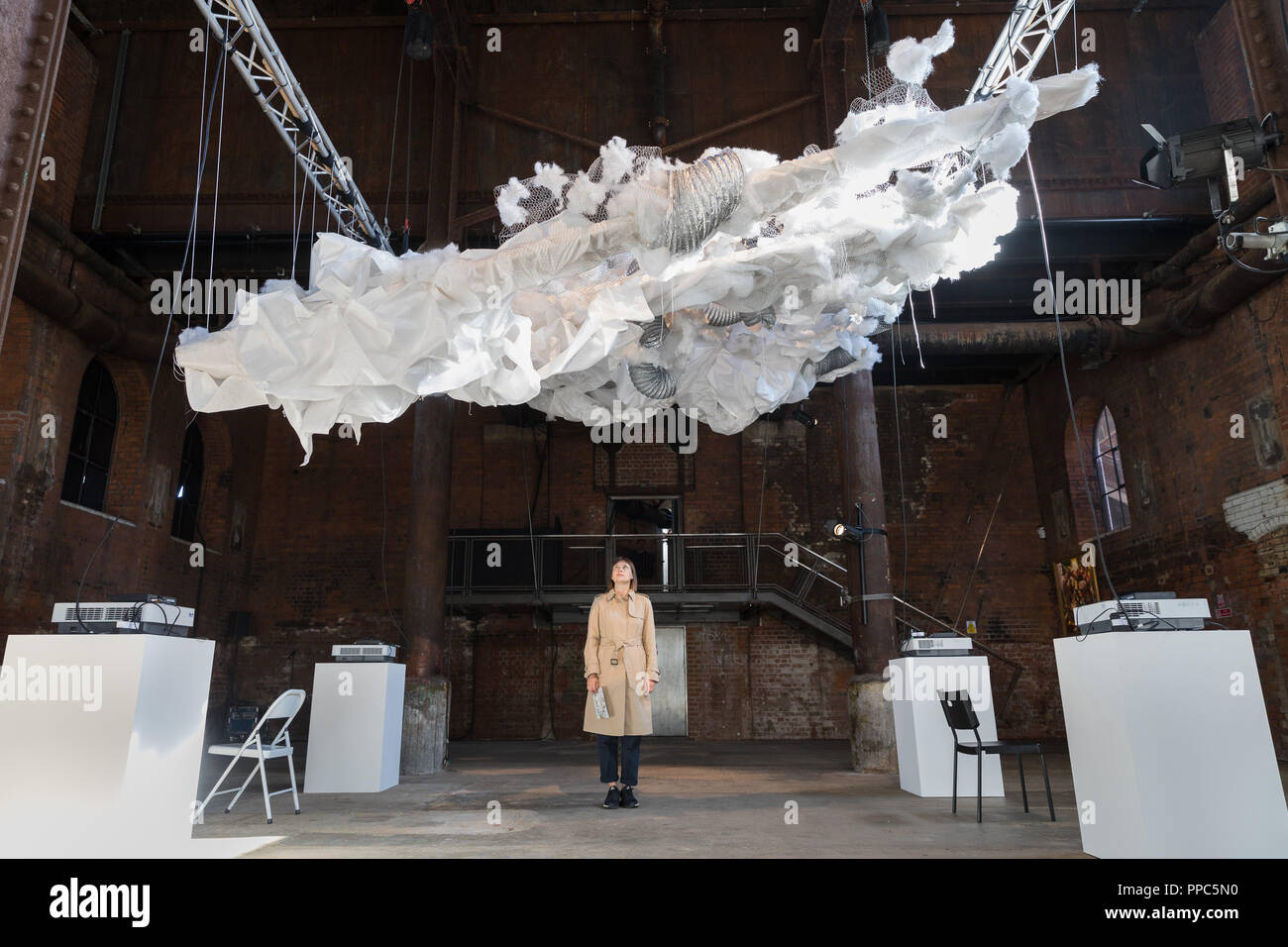 London, UK. 25th September 2018. A visitor looks at Oelun by Kamilla Gabdullina, which is seen suspended from the ceiling. The Focus Kazakhstan: Post-Nomadic Mind exhibition features emerging and established artists and examines Kazakh contemporary art as a form of multi-channel discourse, drawing parallel dialogues between contemporary artists, their Soviet predecessors, and the newly termed subject matter of post-nomadism. The exhibition runs until 16th October 2018. Credit: Vickie Flores/Alamy Live News Stock Photo