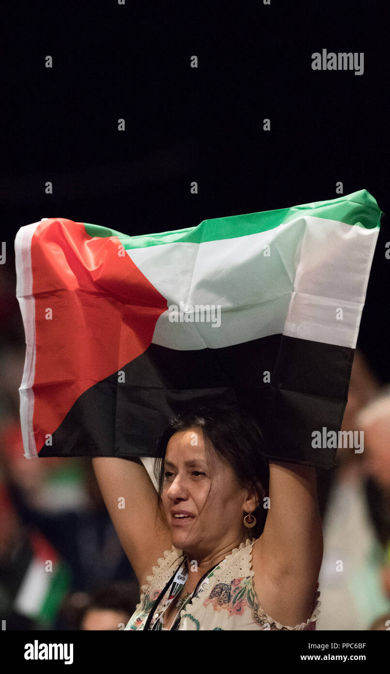 Liverpool, UK. 25th Sep 2018. Labour Party Annual Conference 2018, Albert Docks, Liverpool, England, UK. 25th. September, 2018. Supporters for Free Palestine wave the Palestine flag at the Labour party Conference.Labour Party Annual Conference 2018. Alan Beastall/Alamy Live News Stock Photo