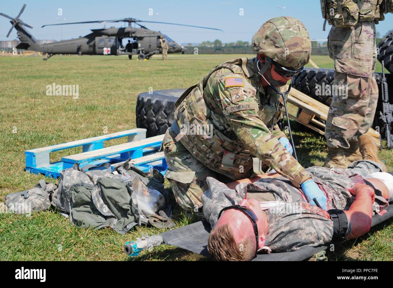U.S. Army Pfc. Jasmine Comeaux a combat medic assigned to The Headquarters and Headquarters Company, 2nd Battalion 5th Cavalry Regiment, 1st Armored Brigade Combat Team, 1st Cavalry Division administers aid to a simulated casualty at Mihail Kogalniceanu Air Base in Romania, August 20, 2018. Soldiers conducted Table VIII Medic Skills Validation, an annual training event required for Soldiers to keep their Military Occupational Specialty qualification as a combat medic. Stock Photo
