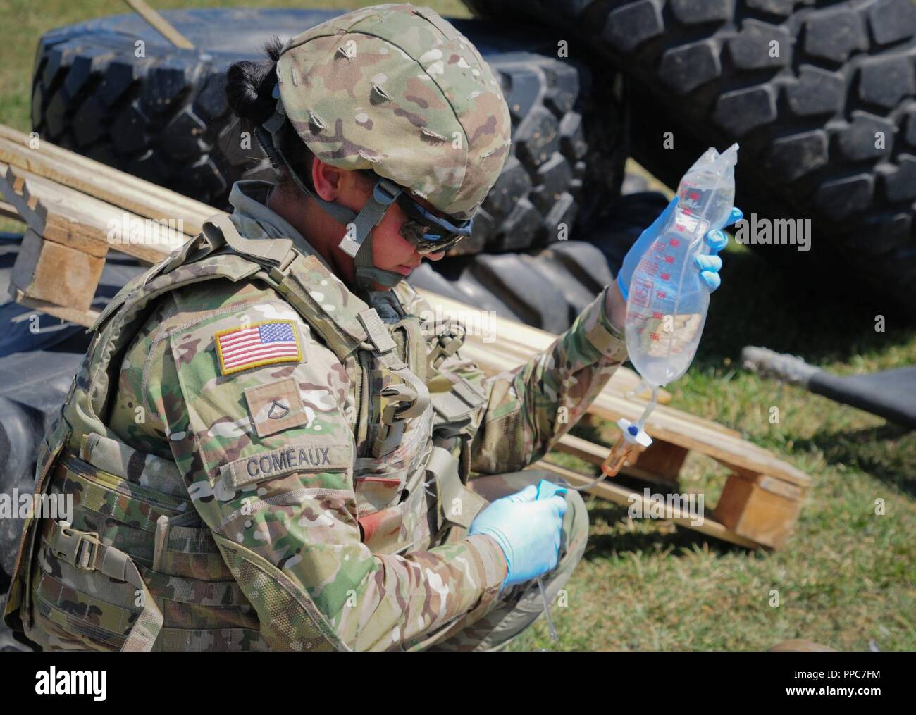 U.S. Army Pfc. Jasmine Comeaux a combat medic assigned to The Headquarters and Headquarters Company, 2nd Battalion 5th Cavalry Regiment, 1st Armored Brigade Combat Team, 1st Cavalry Division administers aid to a simulated casualty at Mihail Kogalniceanu Air Base in Romania, August 20, 2018. Soldiers conducted Table VIII Medic Skills Validation, an annual training event required for Soldiers to keep their Military Occupational Specialty qualification as a combat medic. Stock Photo
