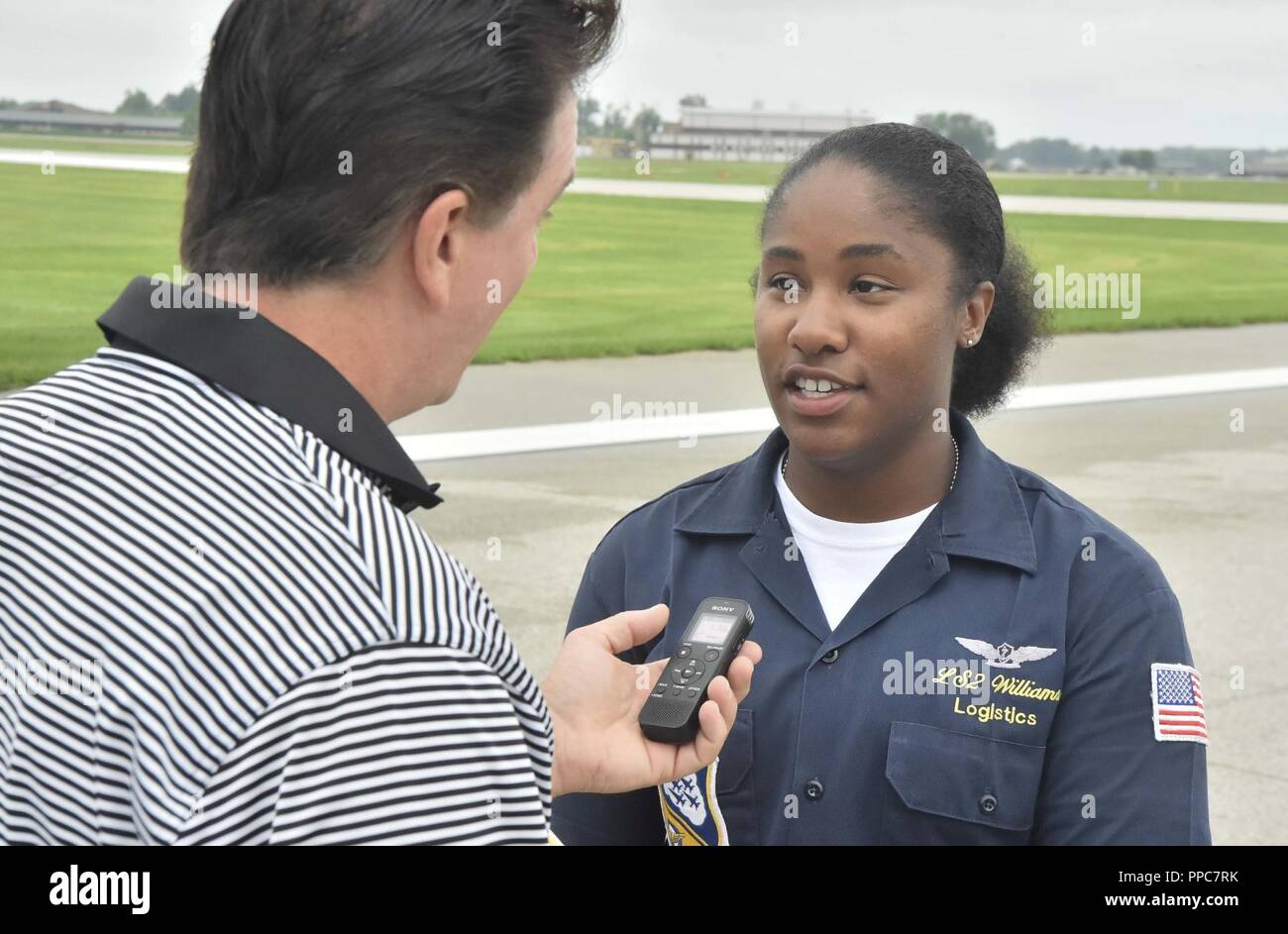 TERRE HAUTE, Indiana. (August 18, 2018) Logistics Specialist 2nd Class DiShawnté Williams, a native of Jonesboro, Geogria, assigned to the U.S. Navy Flight Demonstration Squadron, the Blue Angels, speaks with media prior to the 2018 Terre Haute Air Show. The Blue Angels are scheduled to perform more than 60 demonstrations at more than 30 locations across the U.S. and Canada in 2018. Stock Photo