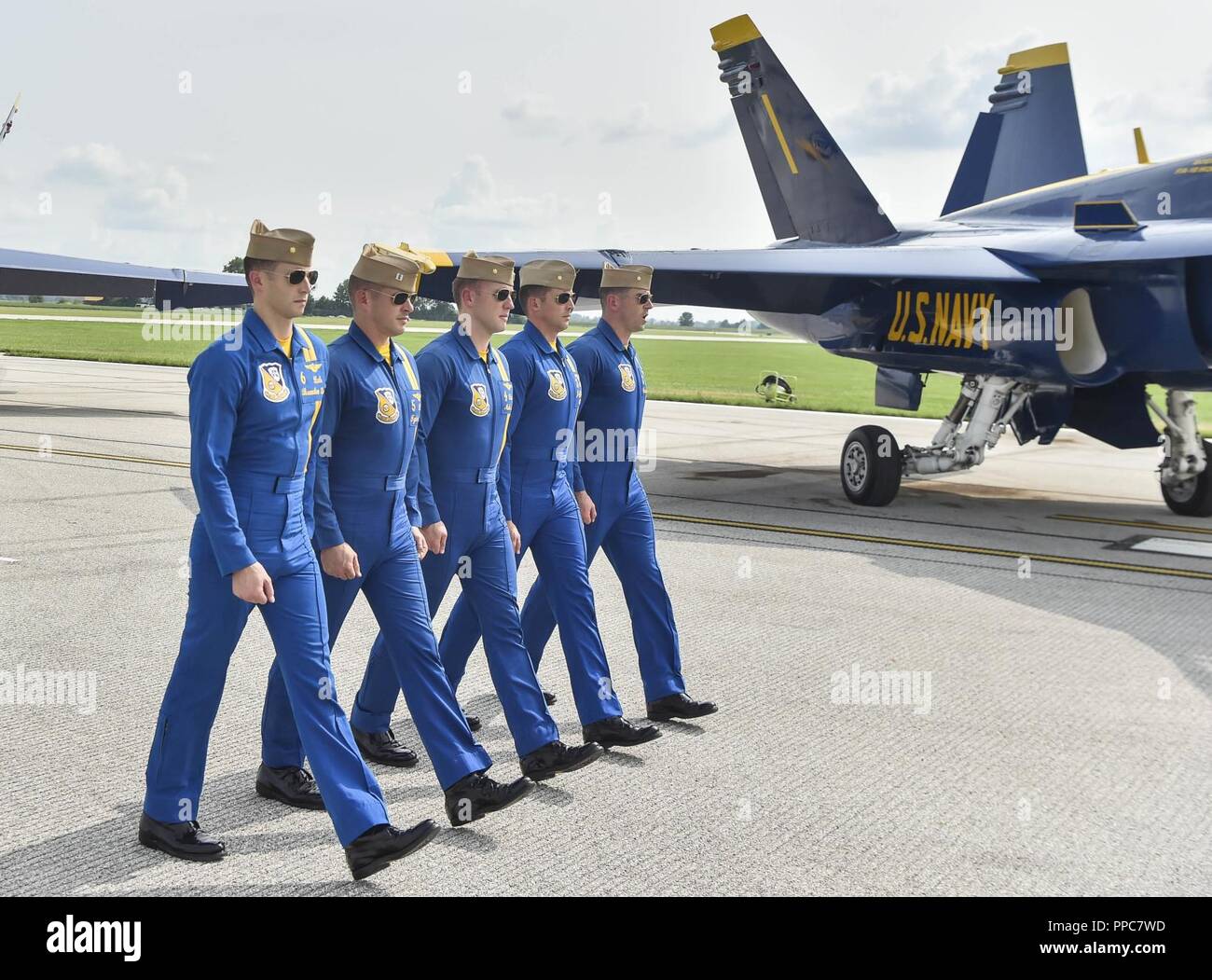 TERRE HAUTE, Indiana. (August 18, 2018) The U.S. Navy Flight Demonstration  Squadron, the Blue Angels, pilots march down the flight line during a  demonstration at the 2018 Terre Haute Air Show. The