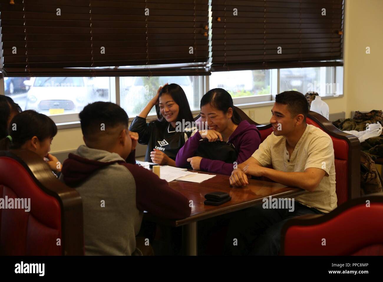 CAMP COURTNEY, OKINAWA, Japan – Students from the local community talk with  Marines during Camp Courtney's Summer English class Aug. 16 at the Camp  Courtney Mess Hall, Okinawa, Japan. This weeklong class