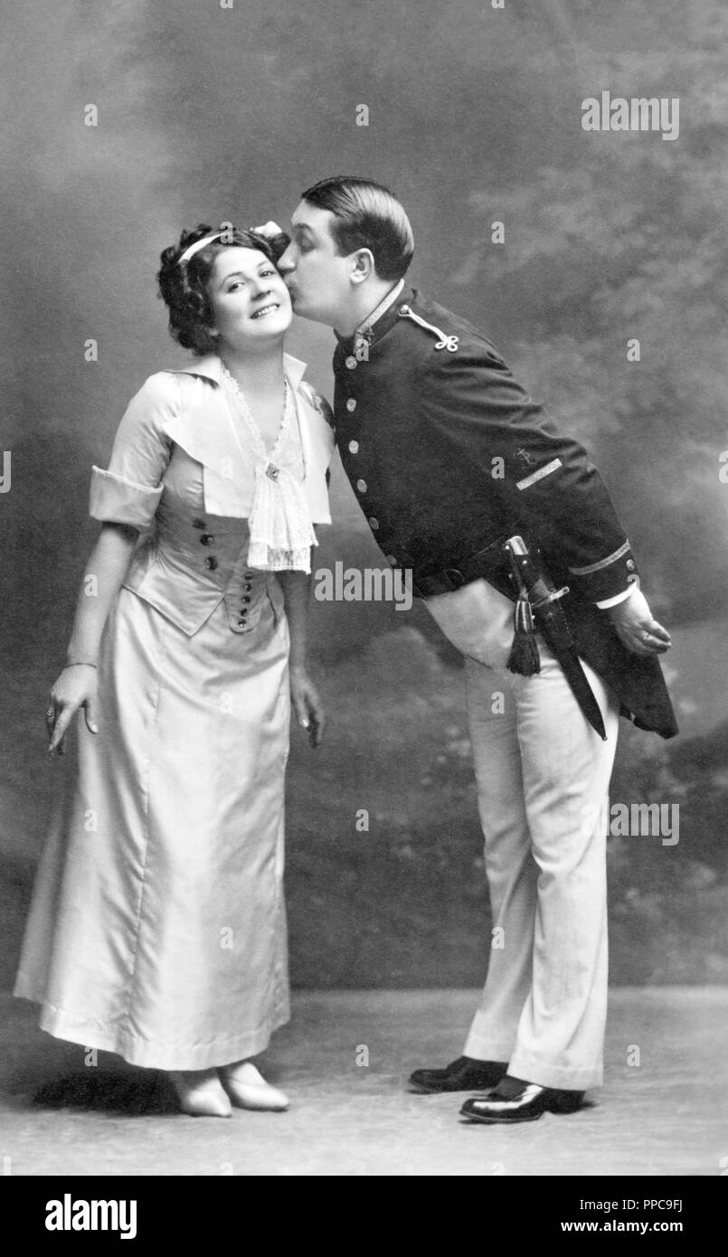 Couples, theater, man in uniform kisses woman on the cheek, 1910s, Vienna, Germany Stock Photo
