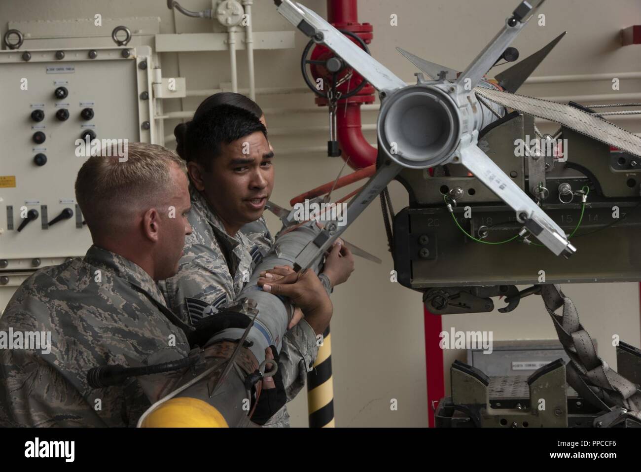 U.S. Air Force Staff Sgt. Bryan Dann, left, 18th Maintenance Group ...