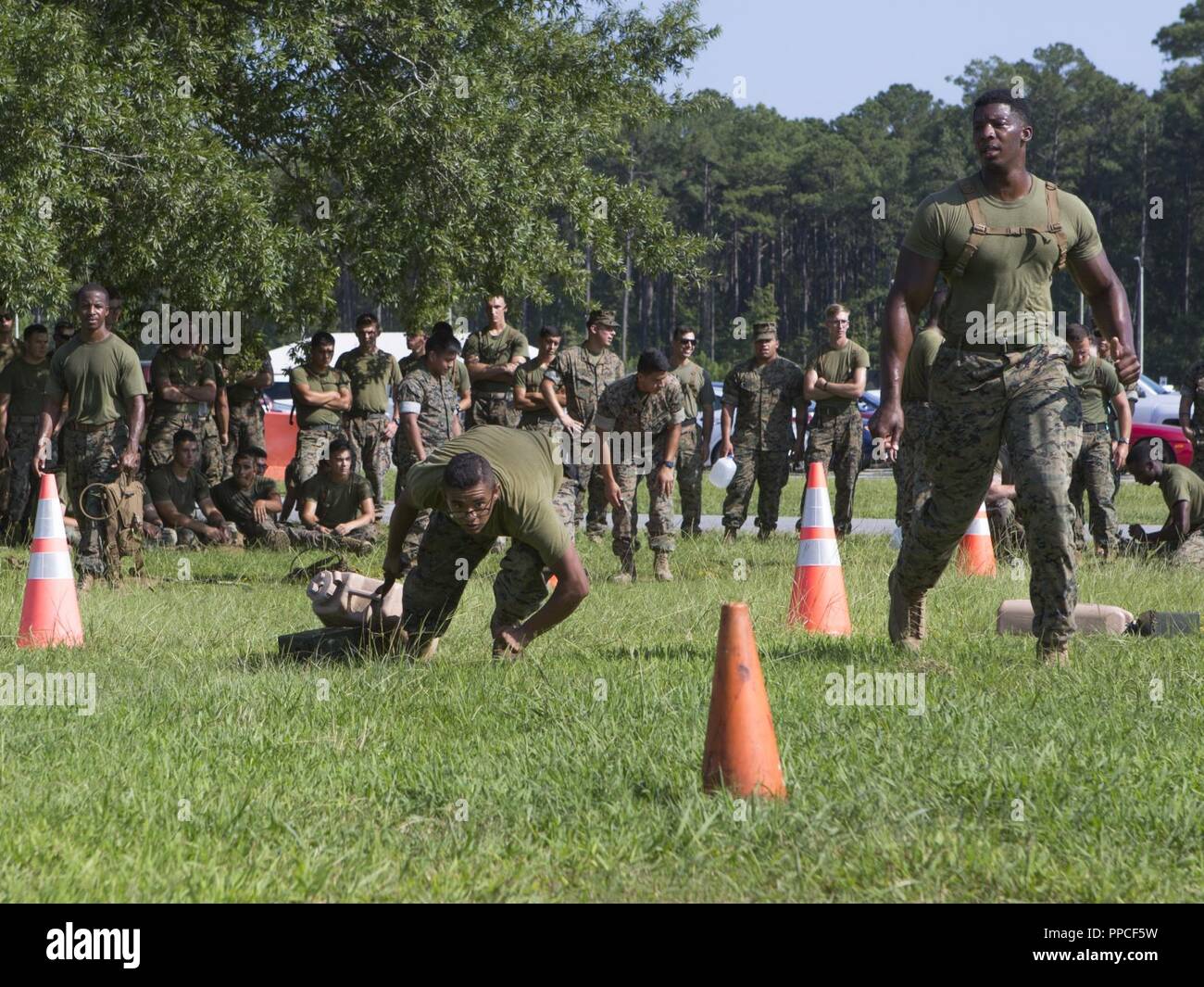 U.S. Marines with Marine Wing Communications Squadron (MWCS) 28, compete in a movement under fire during the Spartan Cup at Marine Corps Air Station Cherry Point, N.C., Aug. 17, 2018. MWCS-28 conducts a semiannual Spartan Cup to raise moral and improve unit cohesion. MWCS-28 is with Marine Air Control Group 28, 2nd Marine Aircraft Wing. Stock Photo