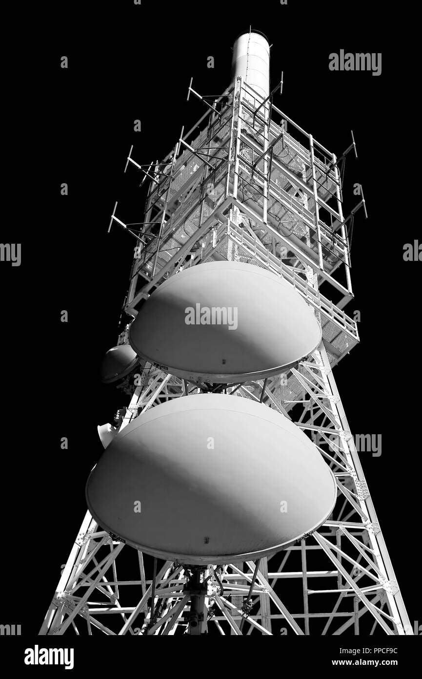 Red and white tower of communication with their antennas - Black and white conversion Stock Photo