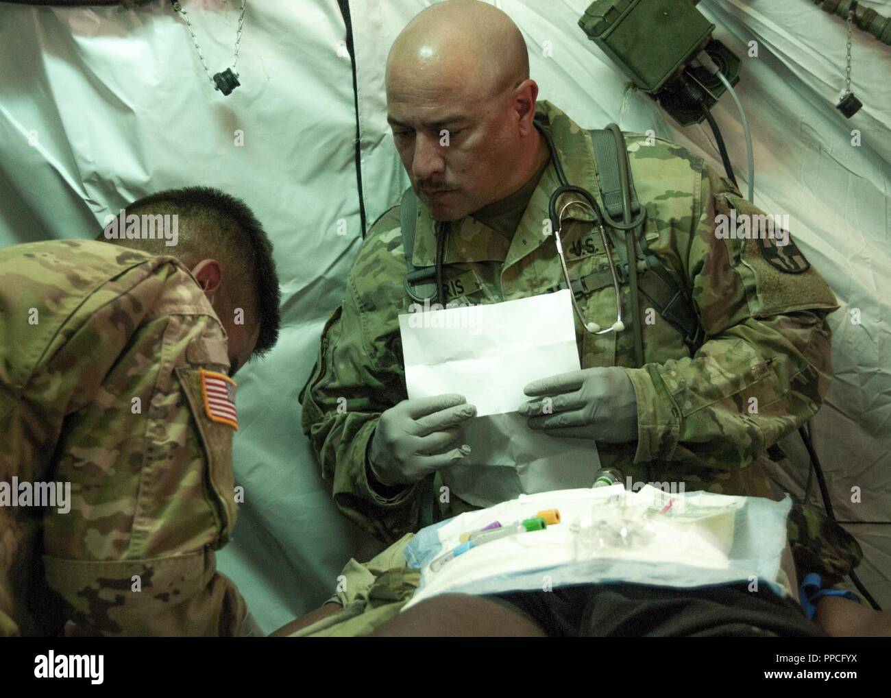 https://c8.alamy.com/comp/PPCFYX/sgt-1st-class-damion-orris-respiratory-therapist-with-the-131st-field-hospital-528th-hospital-center-assesses-a-mock-patient-during-a-simulated-emergency-as-part-of-a-week-long-exercise-at-fort-bliss-aug-15-the-exercise-was-designed-to-test-capabilities-build-rapport-and-increase-efficiency-at-the-armys-second-ever-updated-modular-design-field-hospital-PPCFYX.jpg