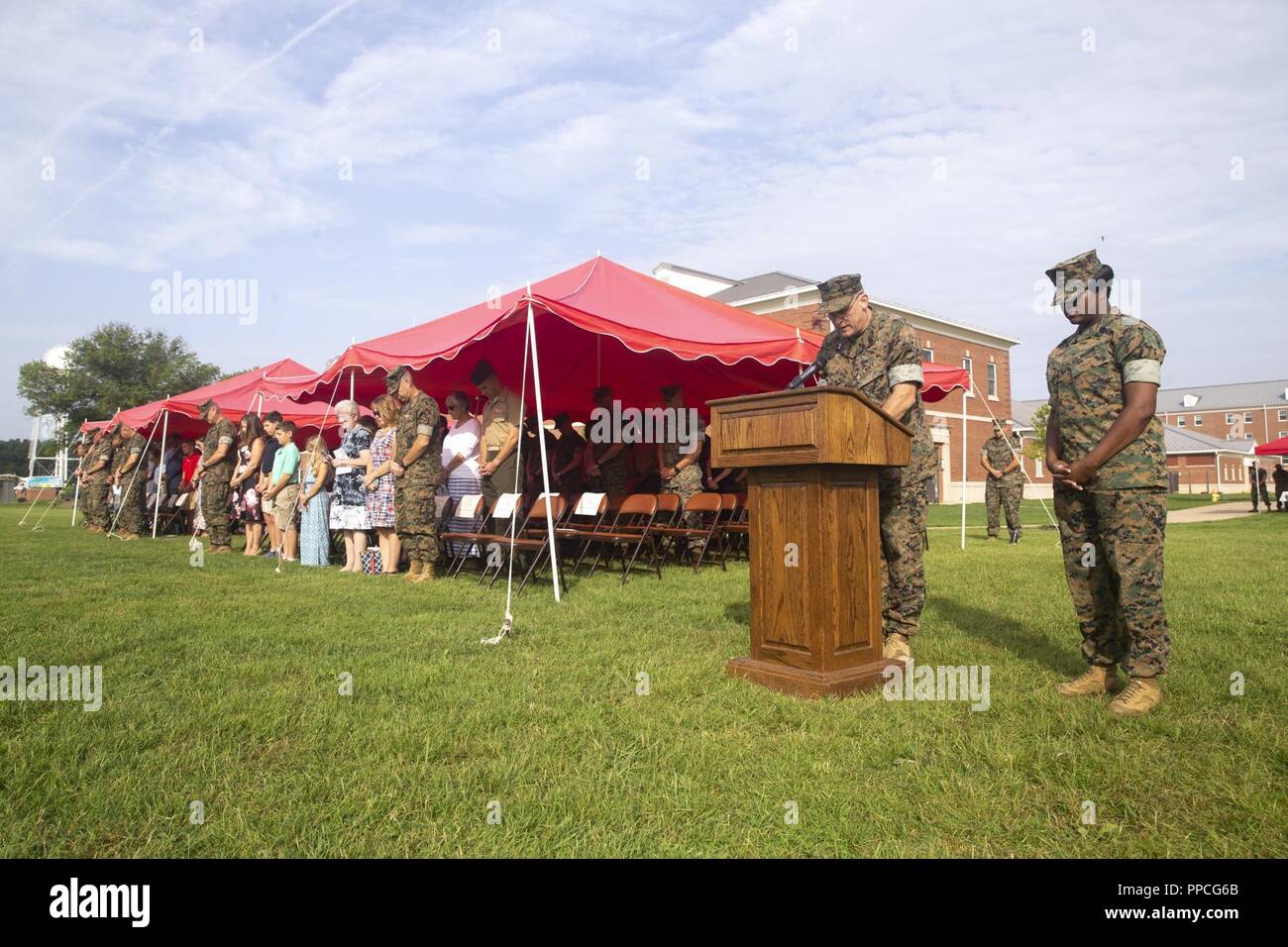 Guests bow their heads for the invocation during the Combat Instructor ...