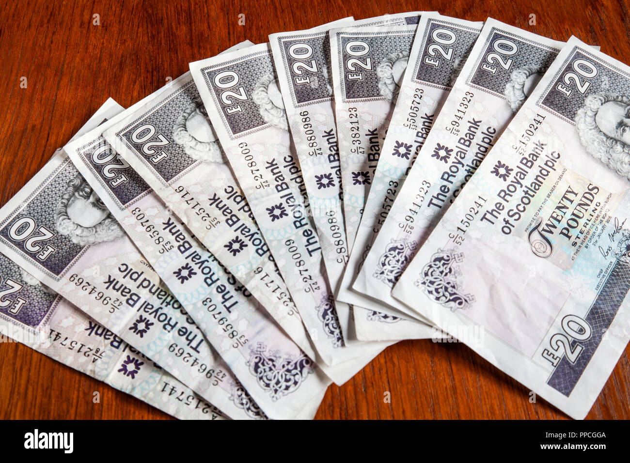 Money on the table: £200 sterling in  Royal Bank of Scotland £20 notes, featuring the Earl of Ilay first governor of the bank. Shallow depth of field. Stock Photo