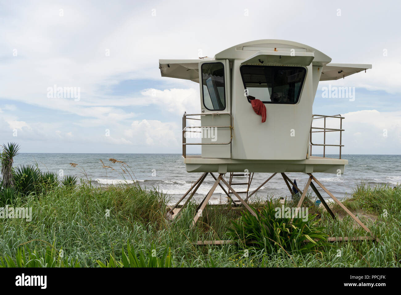 A towel hangs over the window of an elevated coast life guard hut shack Palm Beach Florida Stock Photo