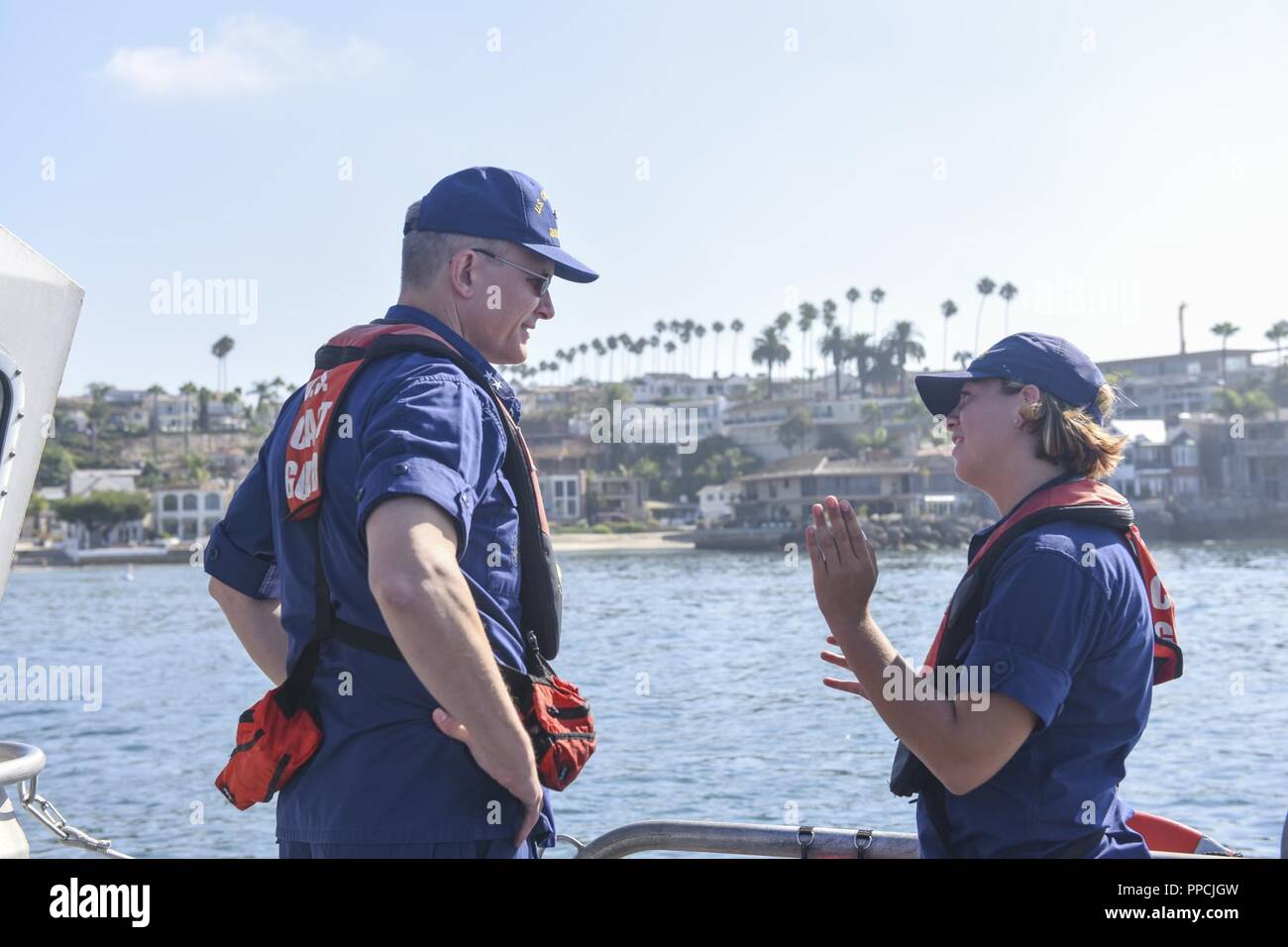 Rear Admiral Peter Gautier, commander, Coast Guard 11th District speaks  with Fireman Ashley Genova assigned to Station Los Angeles-Long Beach about  her future career goals on the deck of a Station LA-LB