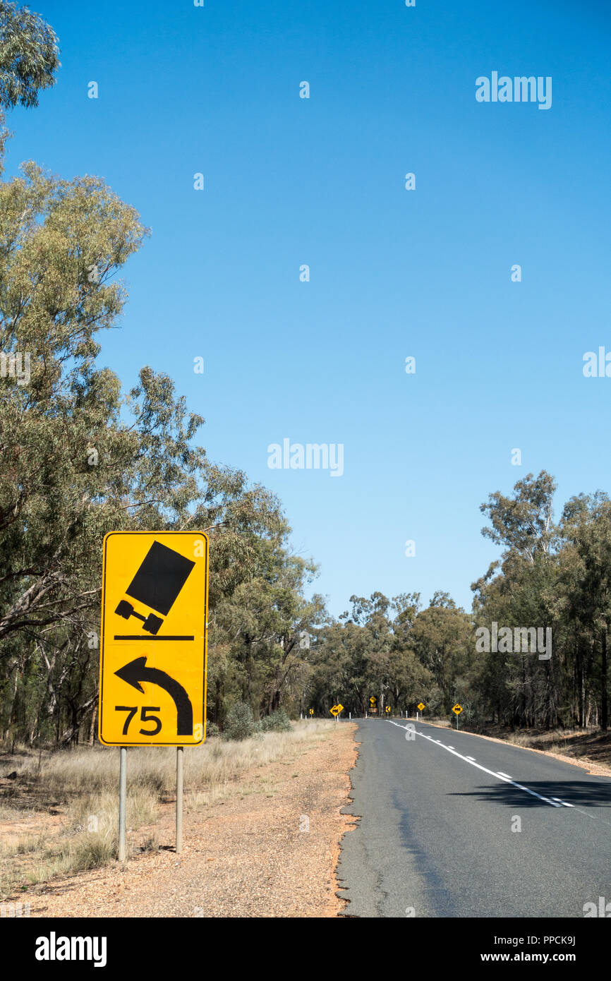 Caution sign for truck drivers to slow to 75 km/h. Rural NSW Australia. Stock Photo