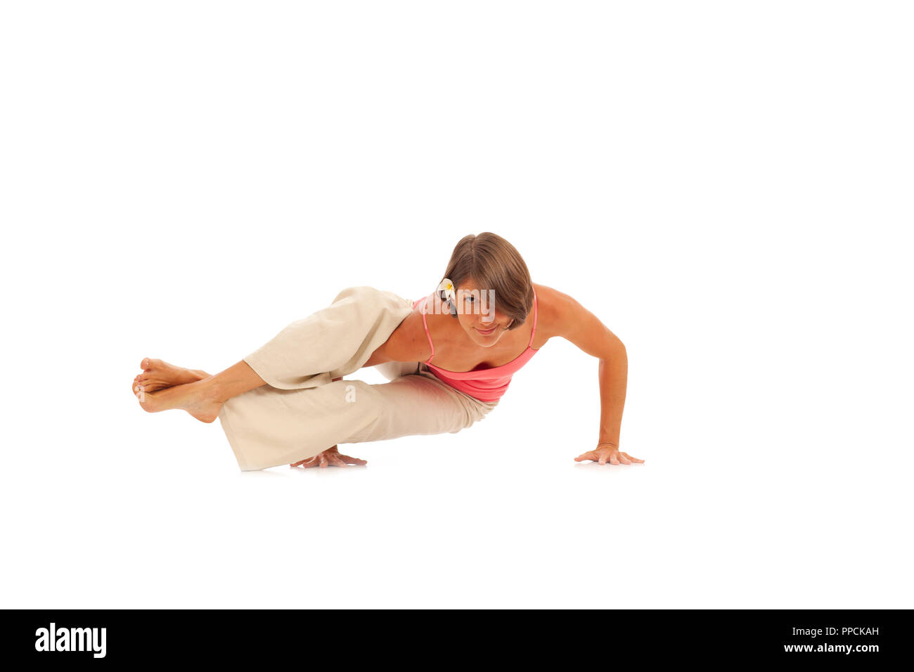 Young woman doing yoga Side Crow Pose Stock Photo - Alamy Young woman doing yoga Side Crow Pose Stock Photo - Alamy
