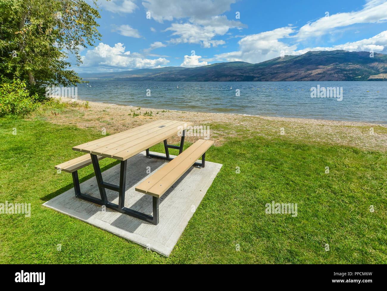 Picnic table and benches near Okanagan lake. Table and benches at rest