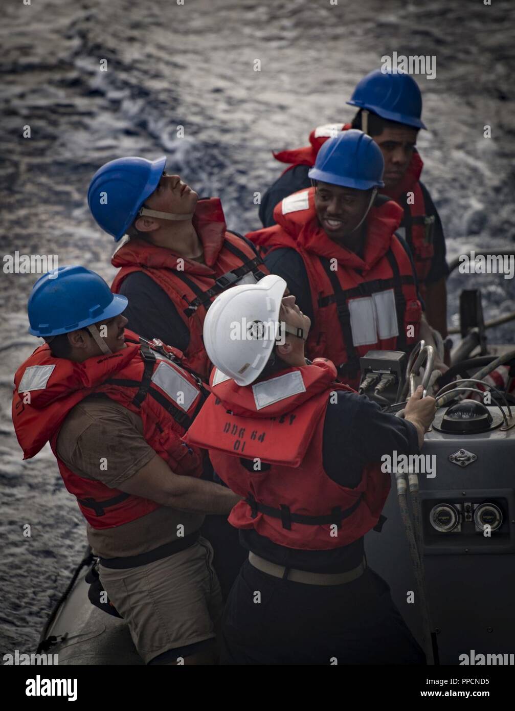 SEA (Aug. 29, 2018) Sailors prepare to raise a rigid-hull inflatable boat aboard the Arleigh Burke-class guided-missile destroyer USS Carney (DDG 64) Aug. 29, 2018. Carney, forward-deployed to Rota, Spain, is on its fifth patrol in the U.S. 6th Fleet area of operations in support of regional allies and partners as well as U.S. national security interests in Europe and Africa. Stock Photo