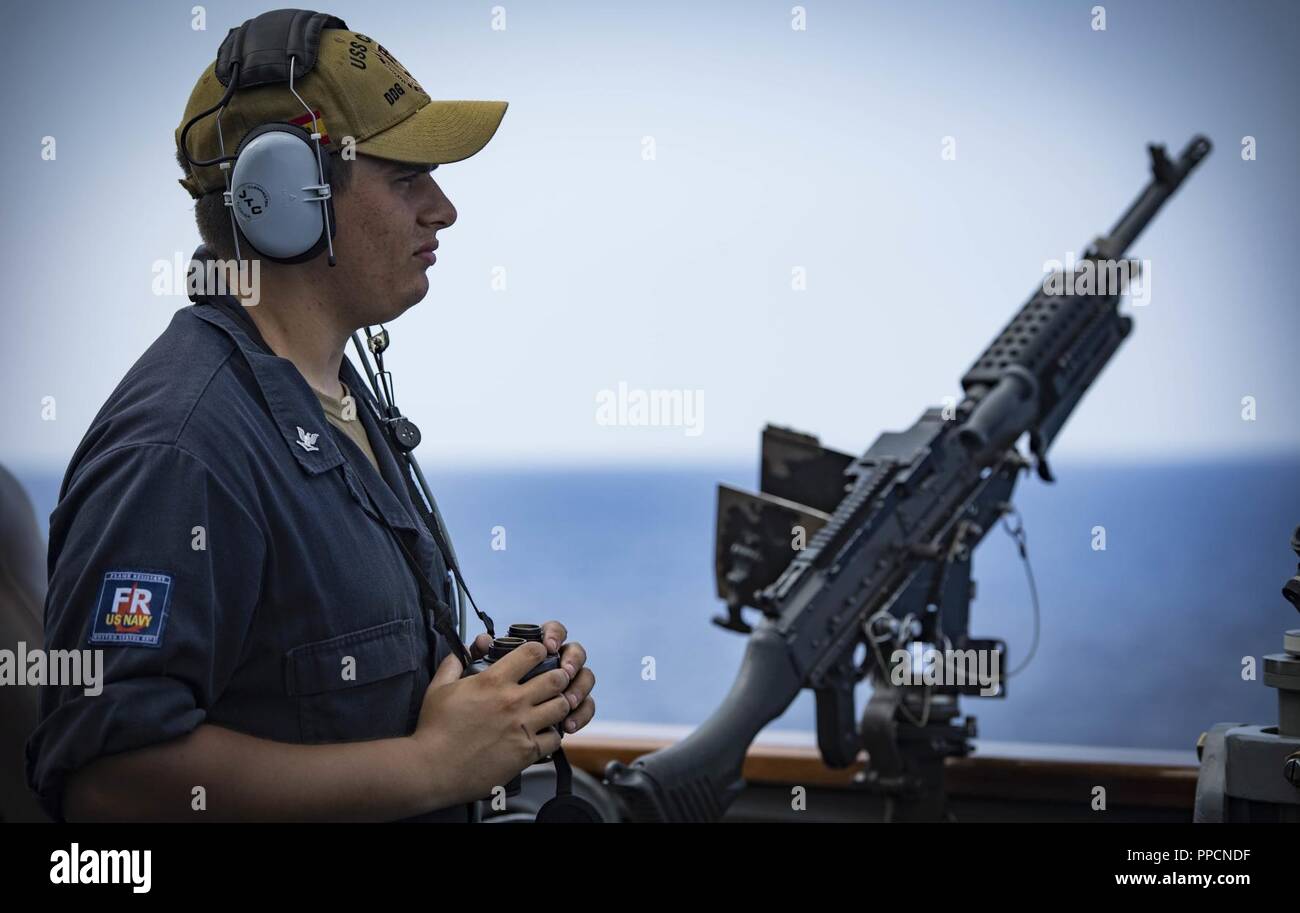 SEA (Aug. 29, 2018) Boatswain’s Mate 3rd Class Aleksander Kaczinski stands port side lookout watch aboard the Arleigh Burke-class guided-missile destroyer USS Carney (DDG 64) Aug. 29, 2018. Carney, forward-deployed to Rota, Spain, is on its fifth patrol in the U.S. 6th Fleet area of operations in support of regional allies and partners as well as U.S. national security interests in Europe and Africa. Stock Photo