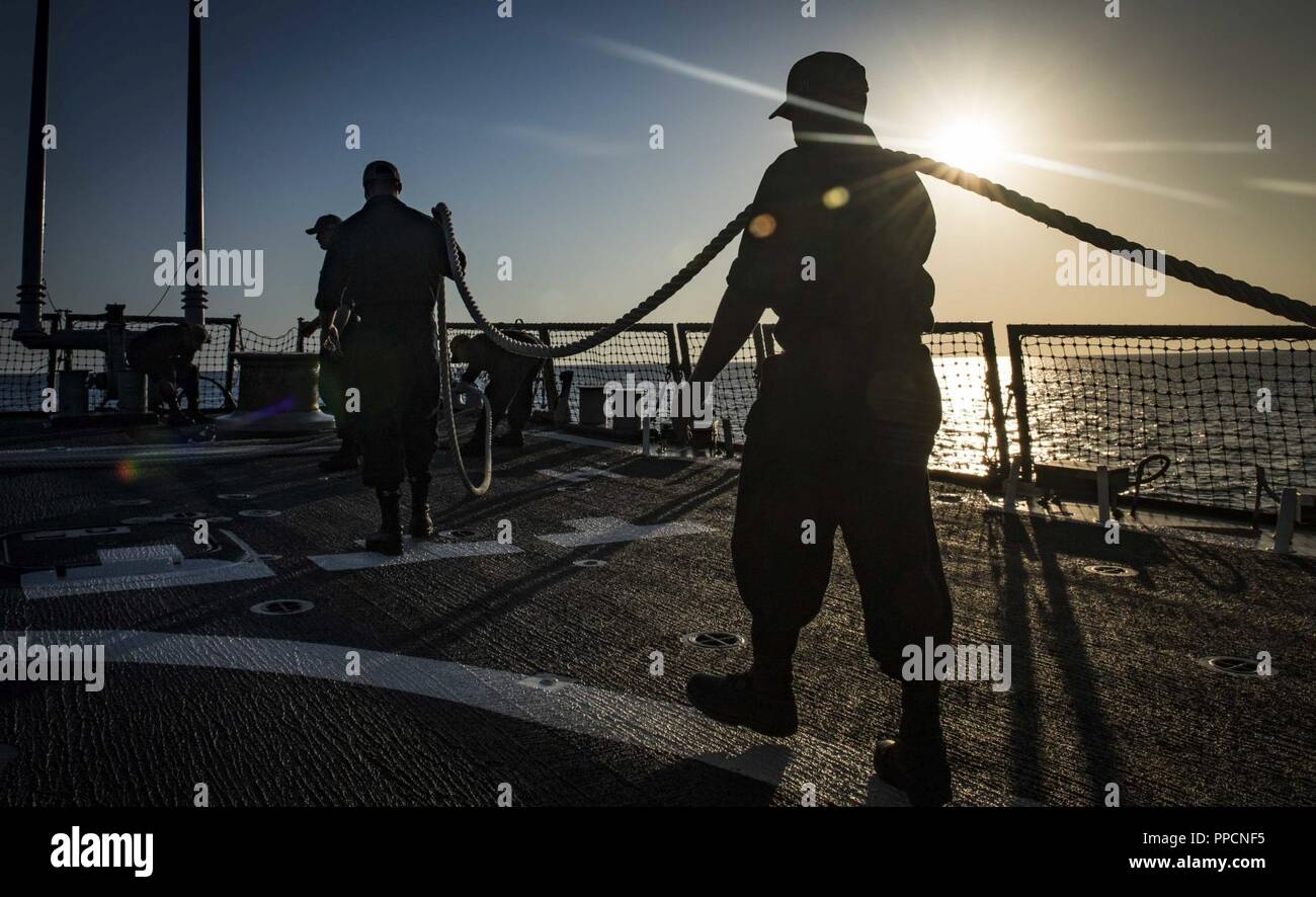 BAY, Greece (Sept. 2, 2018) Sailors handle line aboard the Arleigh Burke-class guided-missile destroyer USS Carney (DDG 64) as the ship arrives in Souda Bay, Greece, Sept. 2, 2018. Carney, forward-deployed to Rota, Spain, is on its fifth patrol in the U.S. 6th Fleet area of operations in support of regional allies and partners as well as U.S. national security interests in Europe and Africa. Stock Photo