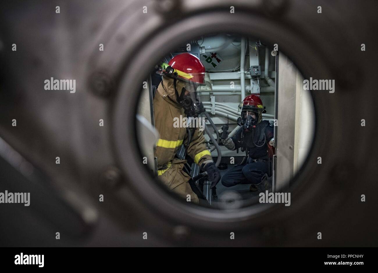 SEA (Aug. 31, 2018) Sailors prepare to combat simulated casualties during a general quarters drill aboard the Arleigh Burke-class guided-missile destroyer USS Carney (DDG 64) Aug. 31, 2018. Carney, forward-deployed to Rota, Spain, is on its fifth patrol in the U.S. 6th Fleet area of operations in support of regional allies and partners as well as U.S. national security interests in Europe and Africa. Stock Photo