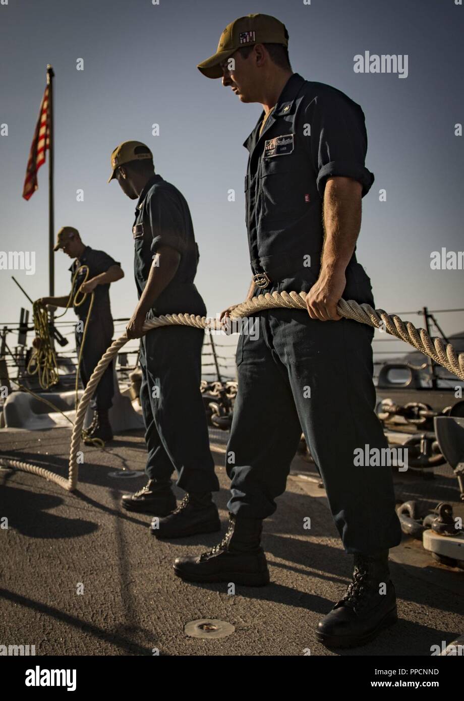 BAY, Greece (Sept. 2, 2018) Sailors handle line aboard the Arleigh Burke-class guided-missile destroyer USS Carney (DDG 64) as the ship arrives in Souda Bay, Greece, Sept. 2, 2018. Carney, forward-deployed to Rota, Spain, is on its fifth patrol in the U.S. 6th Fleet area of operations in support of regional allies and partners as well as U.S. national security interests in Europe and Africa. Stock Photo