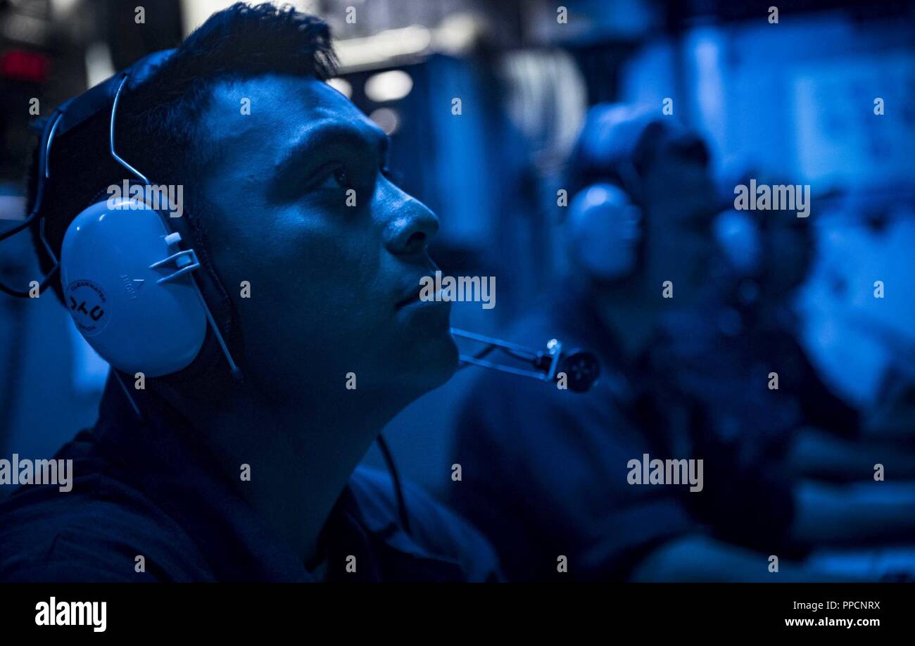 SEA (Sept. 4, 2018) Sonar Technician (Surface) 3rd Class Angel Navasalazar stands watch in the sonar control room aboard the Arleigh Burke-class guided-missile destroyer USS Carney (DDG 64) Sept. 4, 2018. Carney, forward-deployed to Rota, Spain, is on its fifth patrol in the U.S. 6th Fleet area of operations in support of regional allies and partners as well as U.S. national security interests in Europe and Africa. Stock Photo