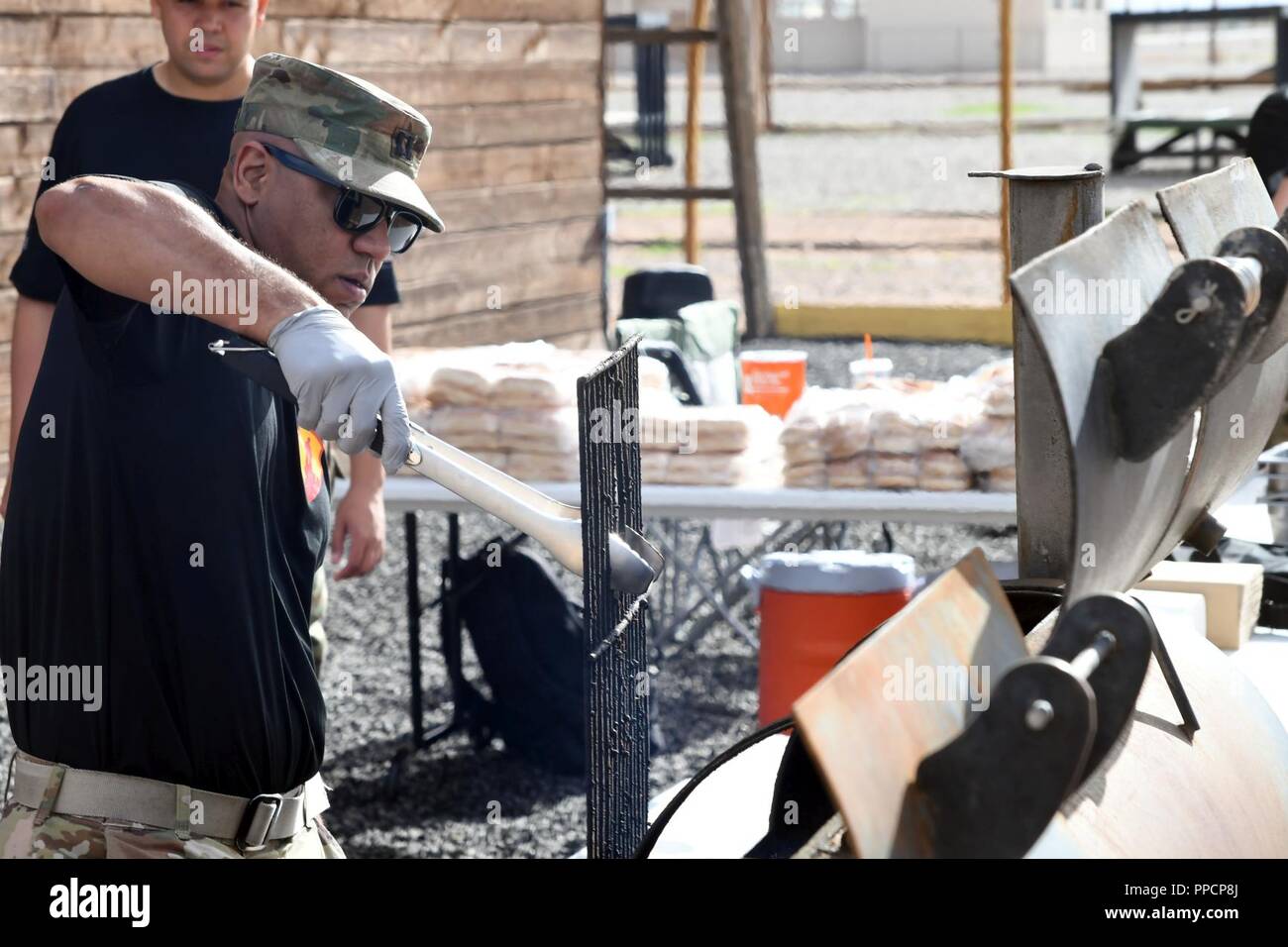 Capt. Jerald Bodden, logistics officer of the 210th Regional Support Group (Aguadilla, Puerto Rico), 1st Mission Support Command, prepares a barbecue grill prior to the start of the third annual Community Outreach Day at Fort Bliss Aug. 25. This year’s event was coordinated by the 210th RSG and the 1st Armored Division Iron Training Detachment - along with volunteers of Child Crisis Center, Big Brothers Big Sisters, and the El Paso Police Department – to mentor and interact with citizens of El Paso, Texas. Stock Photo