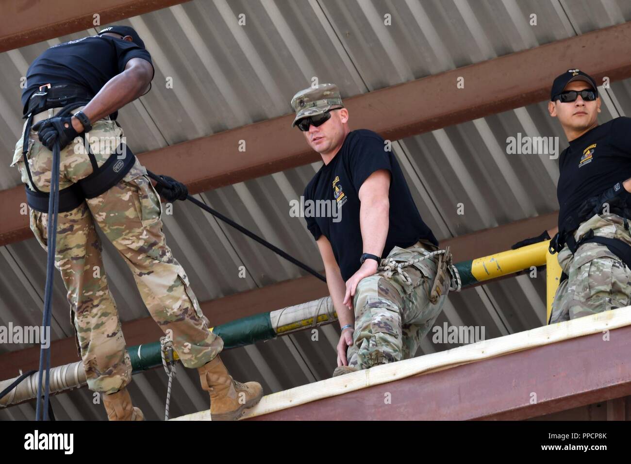 Air Assault Cadre of the 1st Armored Division Iron Training Detachment perform trial rappelling runs at the Air Assault Obstacle Course prior to the start of the third annual Community Outreach Day at Fort Bliss Aug. 25. This year’s event was coordinated by the 210th RSG and the 1st Armored Division Iron Training Detachment - along with volunteers of Child Crisis Center, Big Brothers Big Sisters, and the El Paso Police Department – to mentor and interact with citizens of El Paso, Texas. Stock Photo