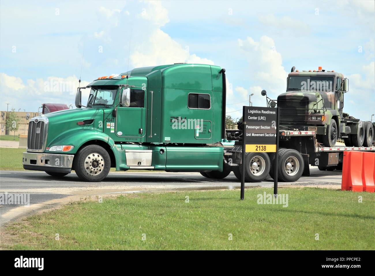 A contracted driver prepares to move a military truck on a semi tractor- trailer Sept. 4, 2018, at Fort McCoy, Wis. The truck was used during the  86th Training Division's Combat Support Training