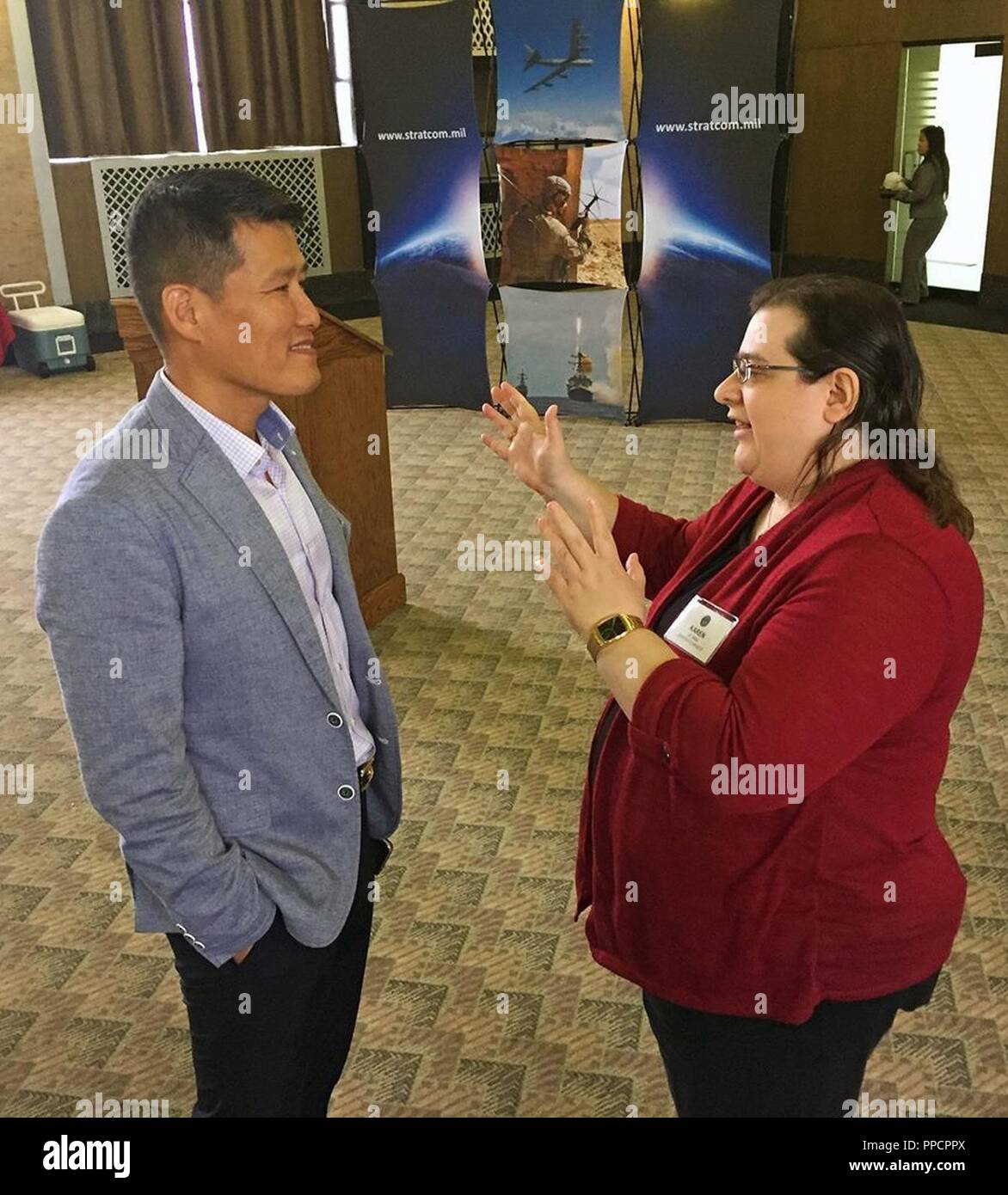 Dr. Karen Miller, U.S. Strategic Command Historian, speaks with Col. Jaehyung Jeong, Republic of Korea Liaison Officer, during a Senior Leader Offsite at the Durham Museum in Omaha, Neb., Aug. 23, 2018. Communication among senior leaders is critical to achieving objectives at USSTRATCOM. Stock Photo