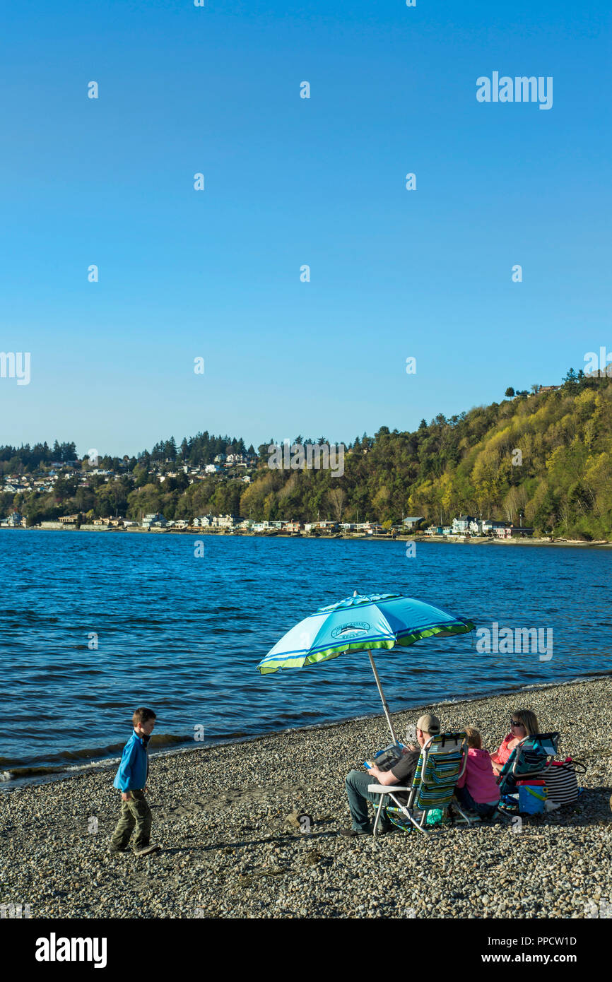 Family with two children relaxing together on coastal beach, Seattle, Washington, USA Stock Photo