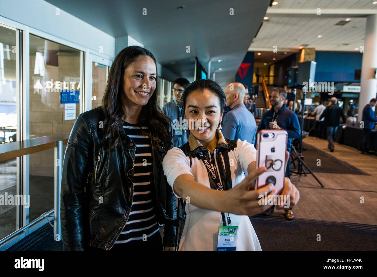 Fangirl taking selfie with female athlete, Seattle, Washington, USA Stock Photo
