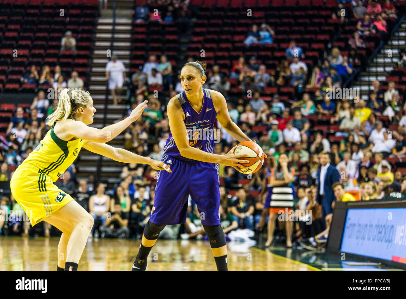 Two female basketball players of opposing teams during game, Seattle, Washington, USA Stock Photo