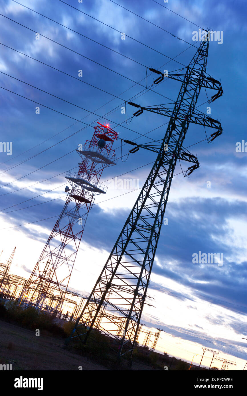 Electricity - Power energy Industry - Electric poles at the sunset with coloful sky Stock Photo