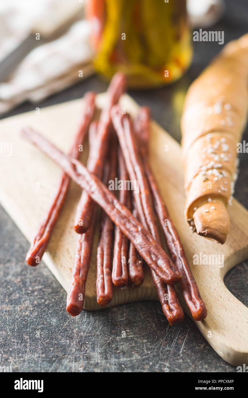 Sausage sticks snack. Chorizo snack on cutting board Stock Photo Alamy