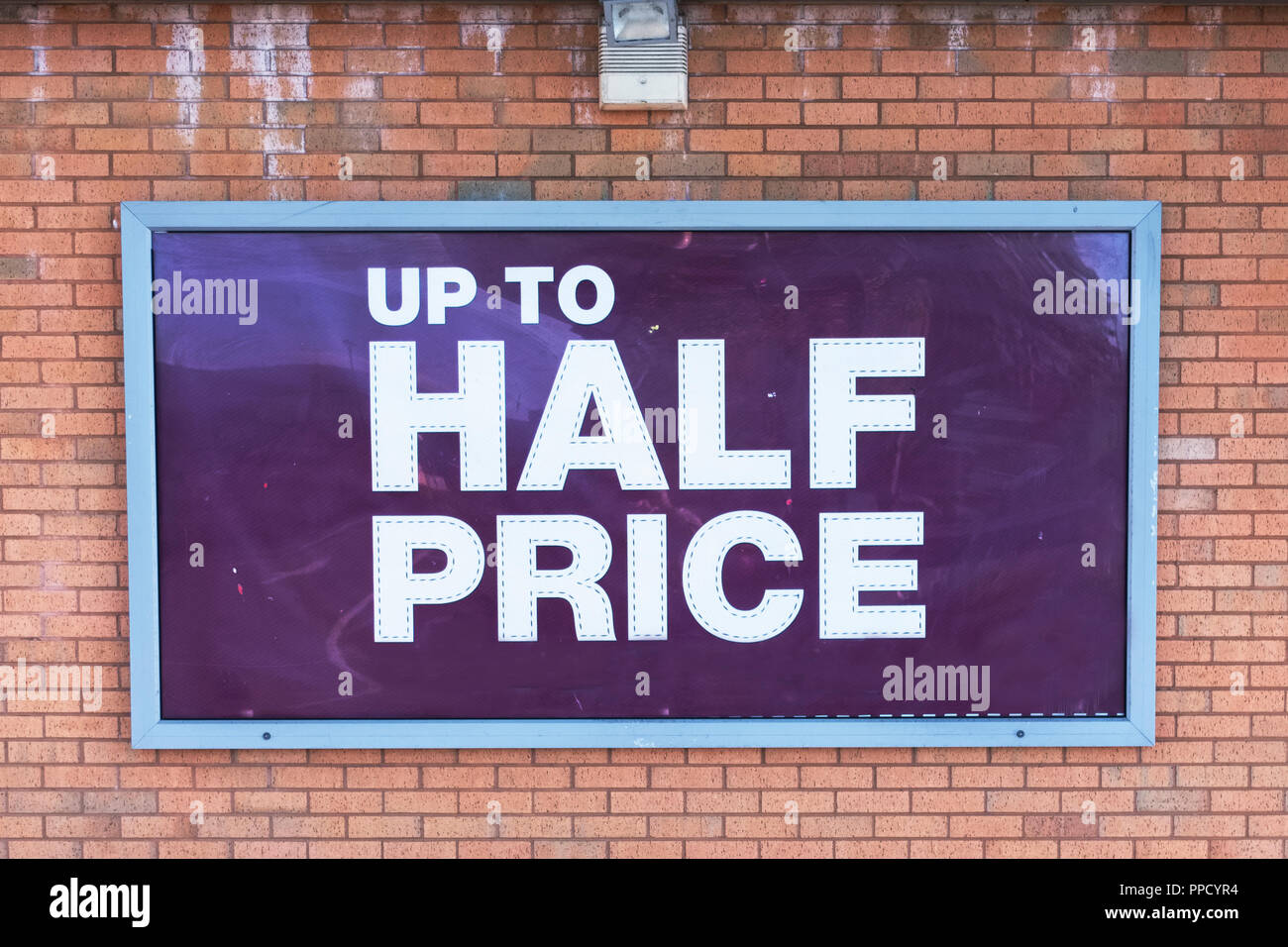 Half price shop sign banner on wall Stock Photo Alamy