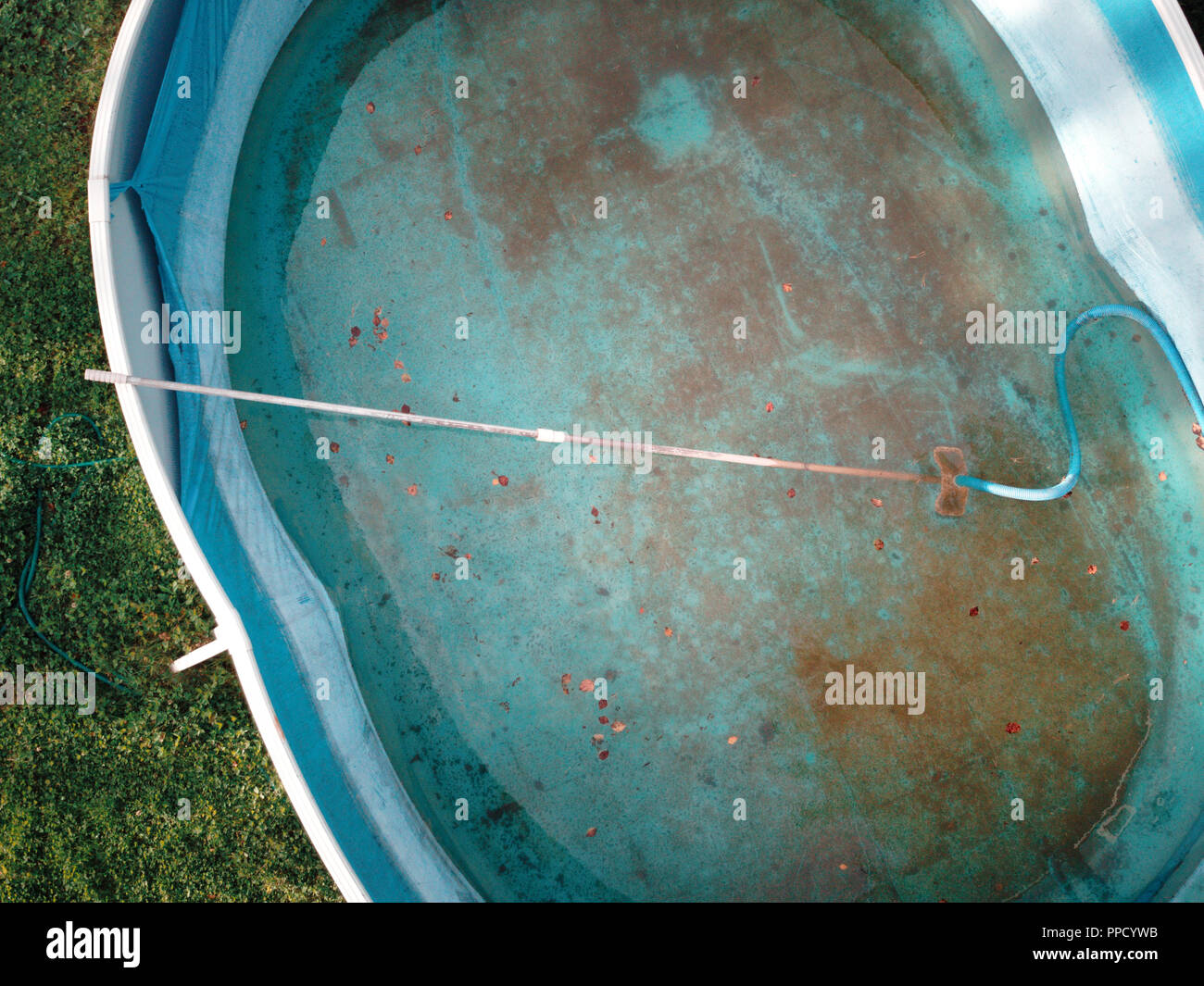 Overhead view of a half empty swimming pool needs to be cleaned Stock